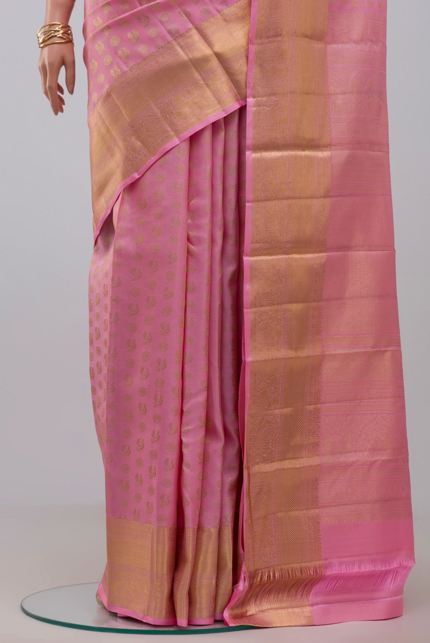 Pleats and pallu of Pink Kanchipuram Silk Saree with Zari Butta on the body and Zari Border. 