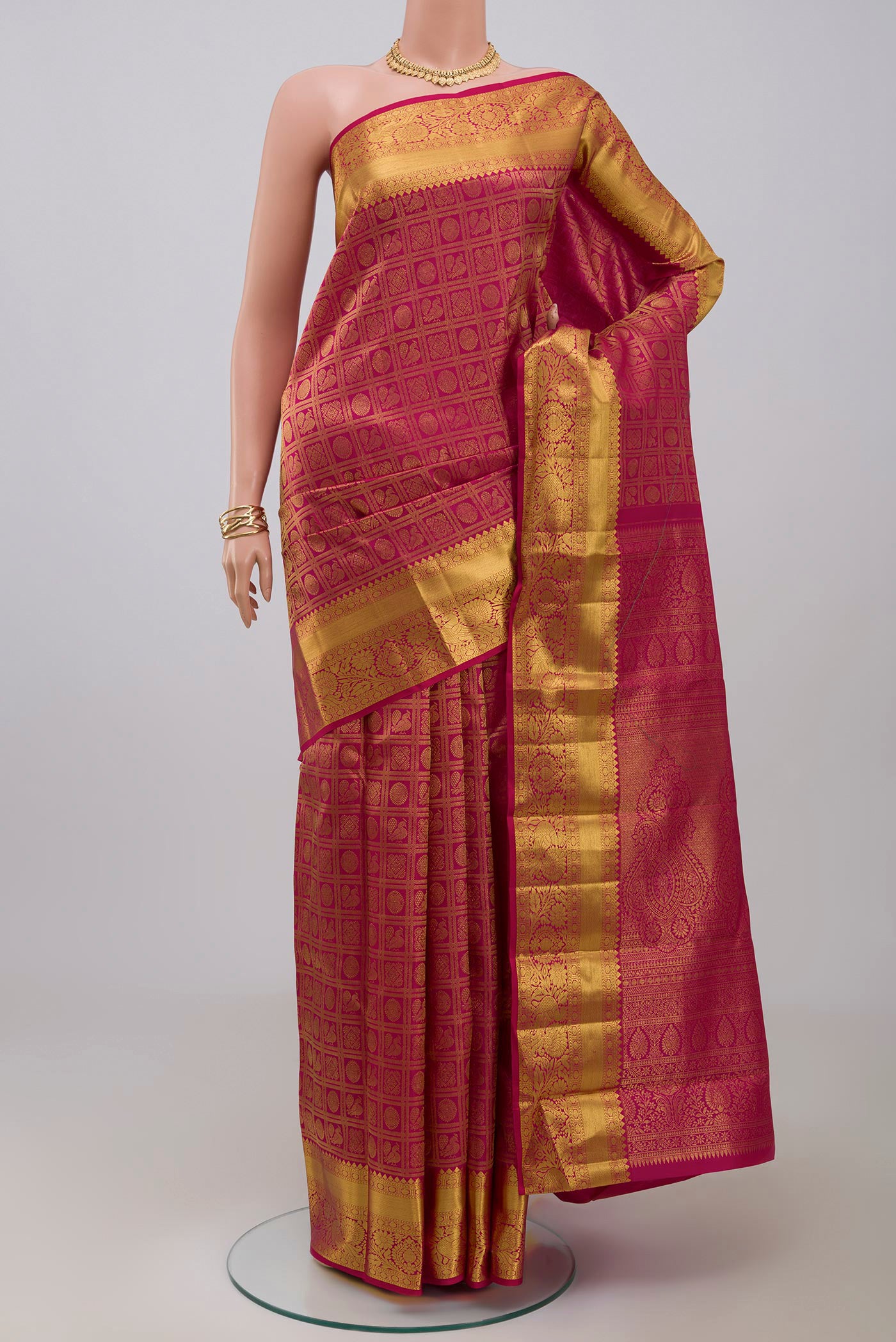 Pink Kanchipuram Silk Saree with Zari Brocade on the body and Zari Border.  displayed on a mannequin
