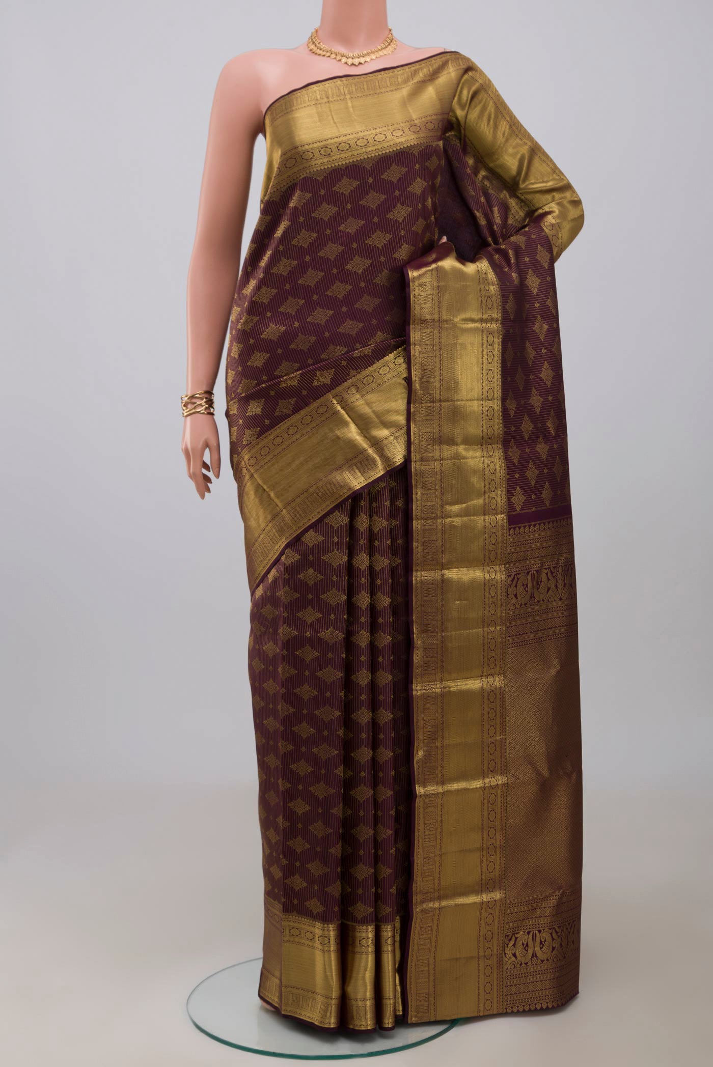 Purple Kanchipuram Silk Saree with Zari Brocade on the body and Zari Border.  displayed on a mannequin