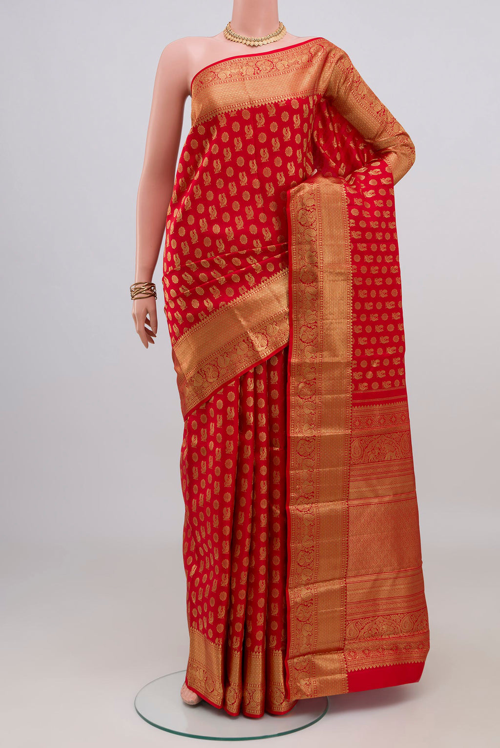 Red Kanchipuram Silk Saree with Zari Butta on the body and Zari Border.  displayed on a mannequin