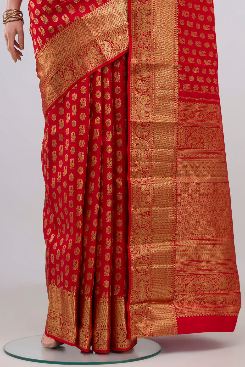 Pleats and pallu of Red Kanchipuram Silk Saree with Zari Butta on the body and Zari Border. 