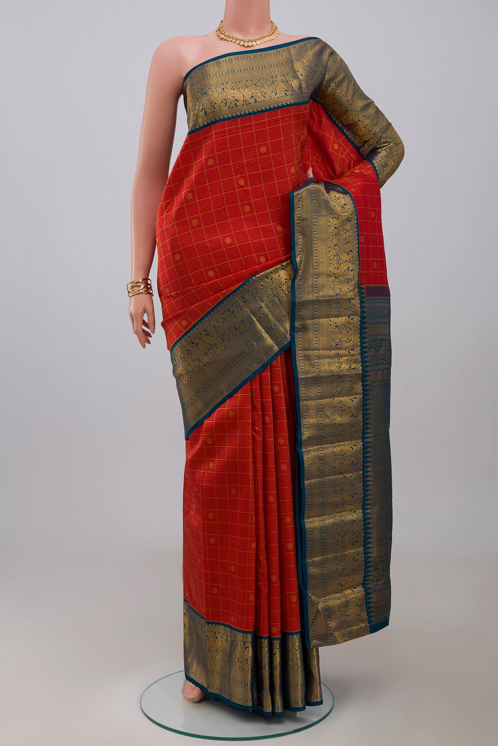 Red Kanjivaram Saree with Zari Brocade on the body and Zari Border.  displayed on a mannequin