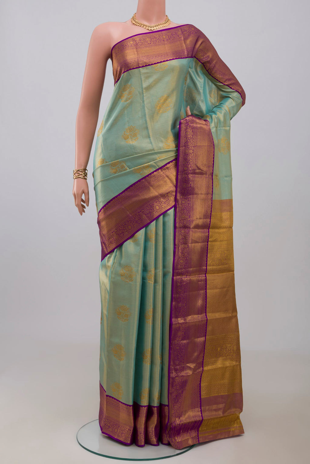 Sky Blue Kanchipuram Silk Saree with Zari Butta on the body and Zari Border.  displayed on a mannequin