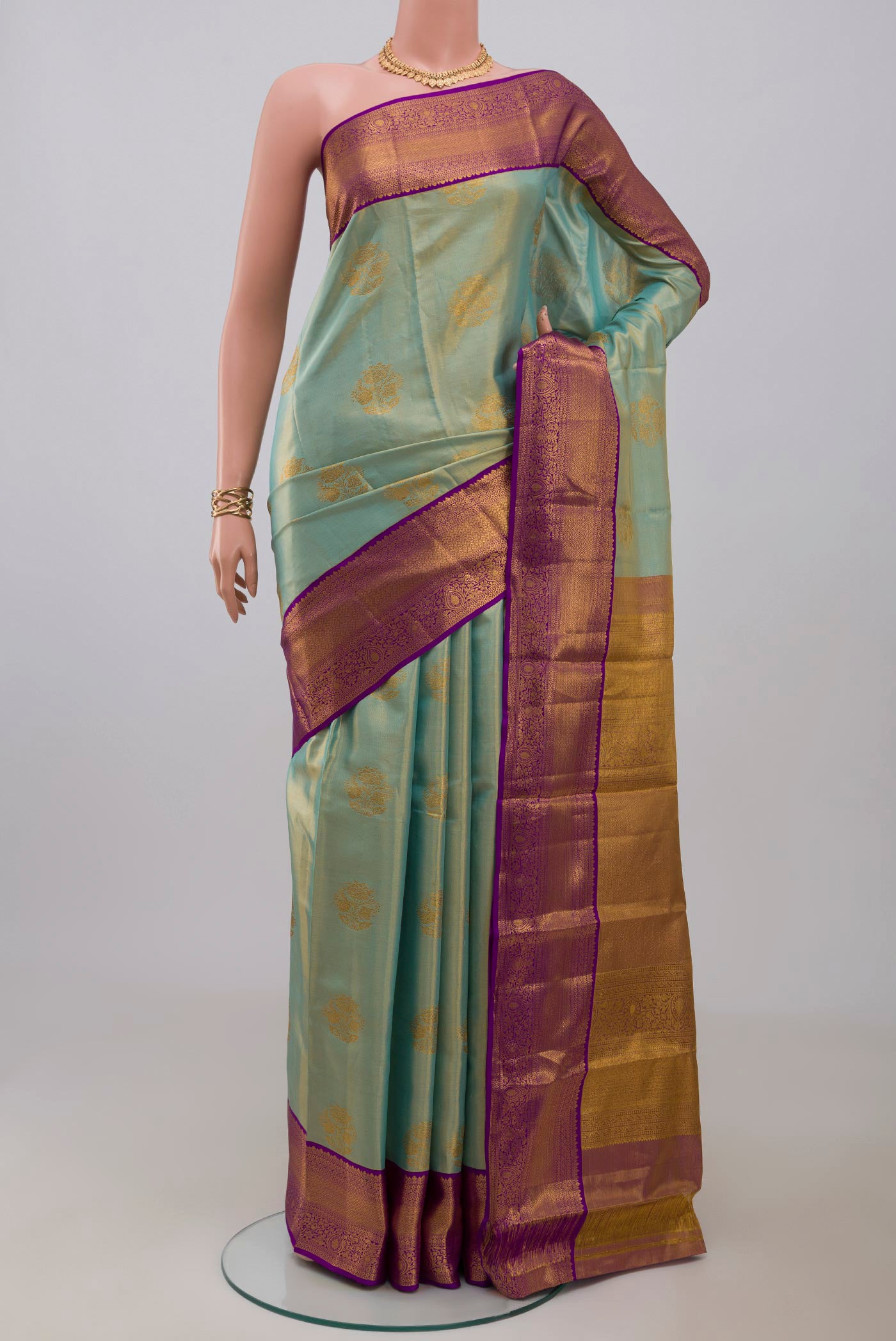 Sky Blue Kanchipuram Silk Saree with Zari Butta on the body and Zari Border.  displayed on a mannequin