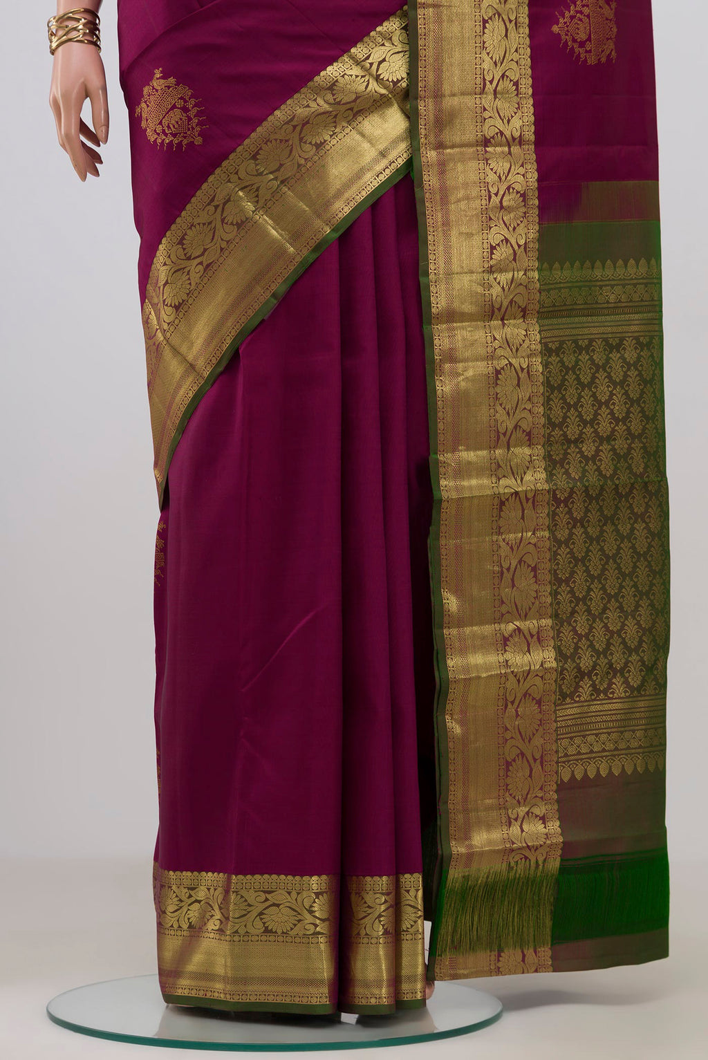 Pleats and pallu of Magenta Kanchipuram Silk Saree with Zari Butta on the body and Zari Border. 