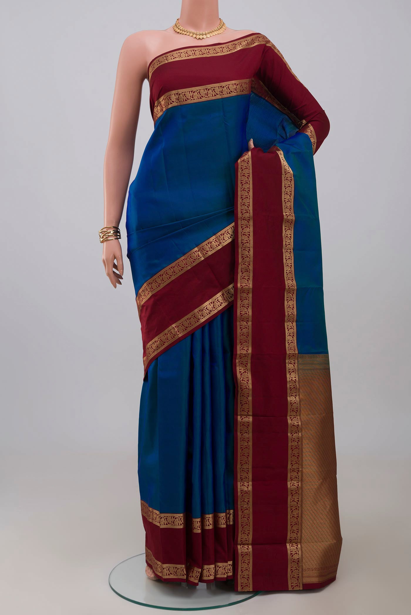 Blue Kanchipuram Saree with Plain Body and Zari Border.  displayed on a mannequin