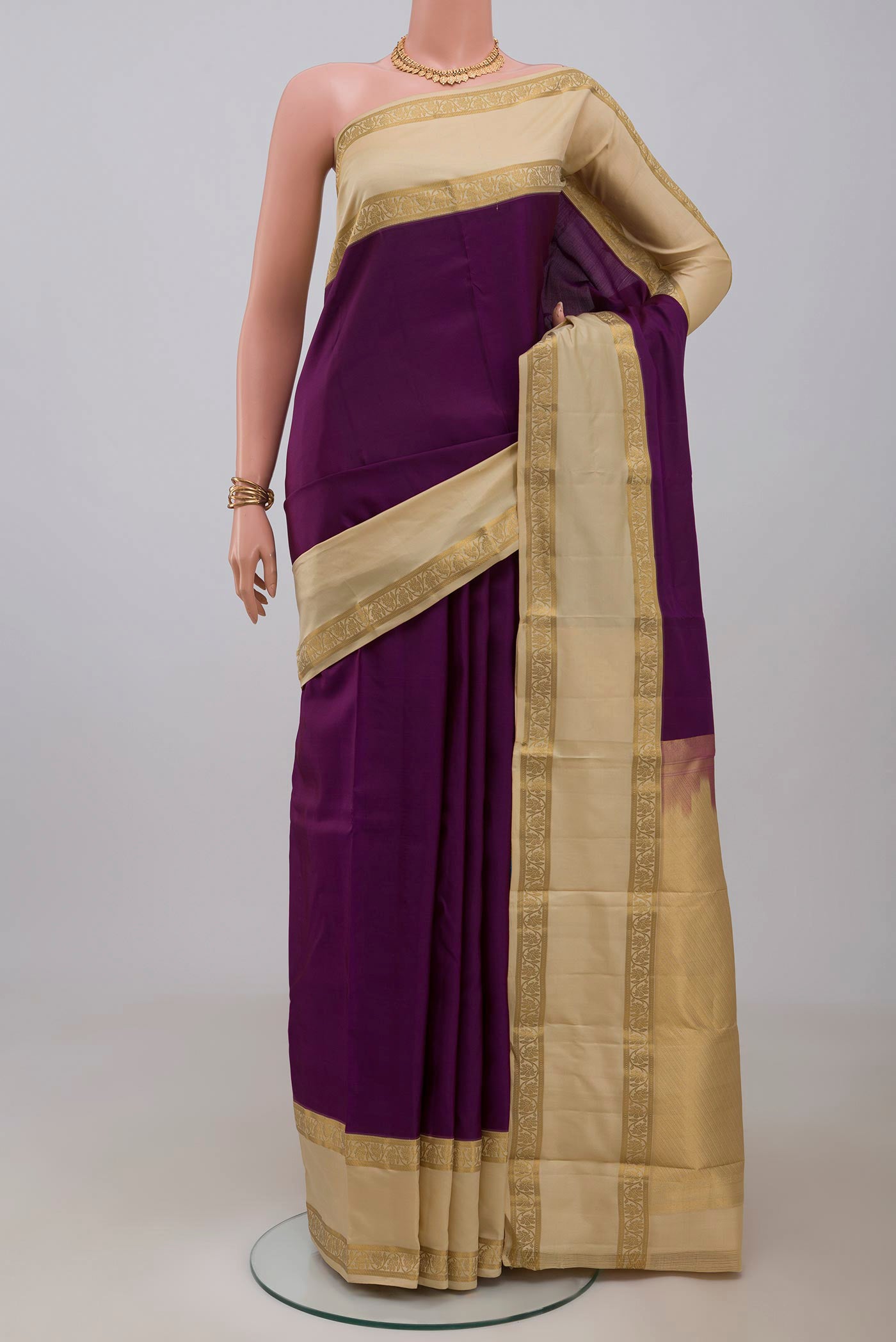 Purple Kanchipuram Silk Saree with Plain Body and Zari Border.  displayed on a mannequin