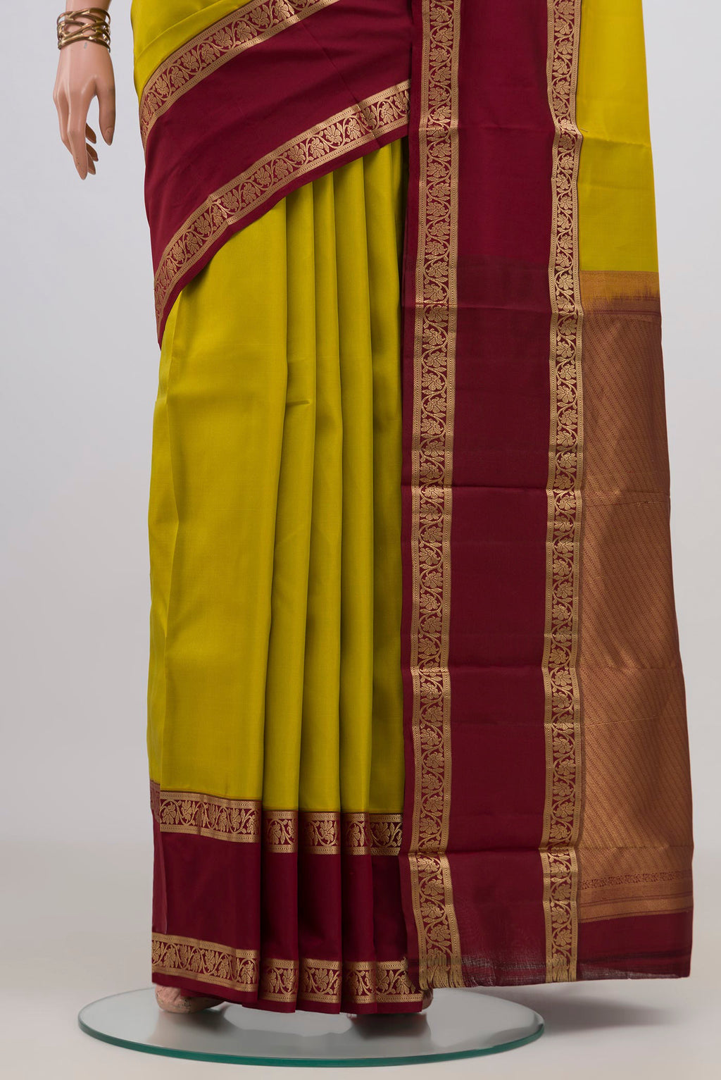 Pleats and pallu of Pure Silk Yellow Kanchipuram Saree with Plain Body and Zari Border. 
