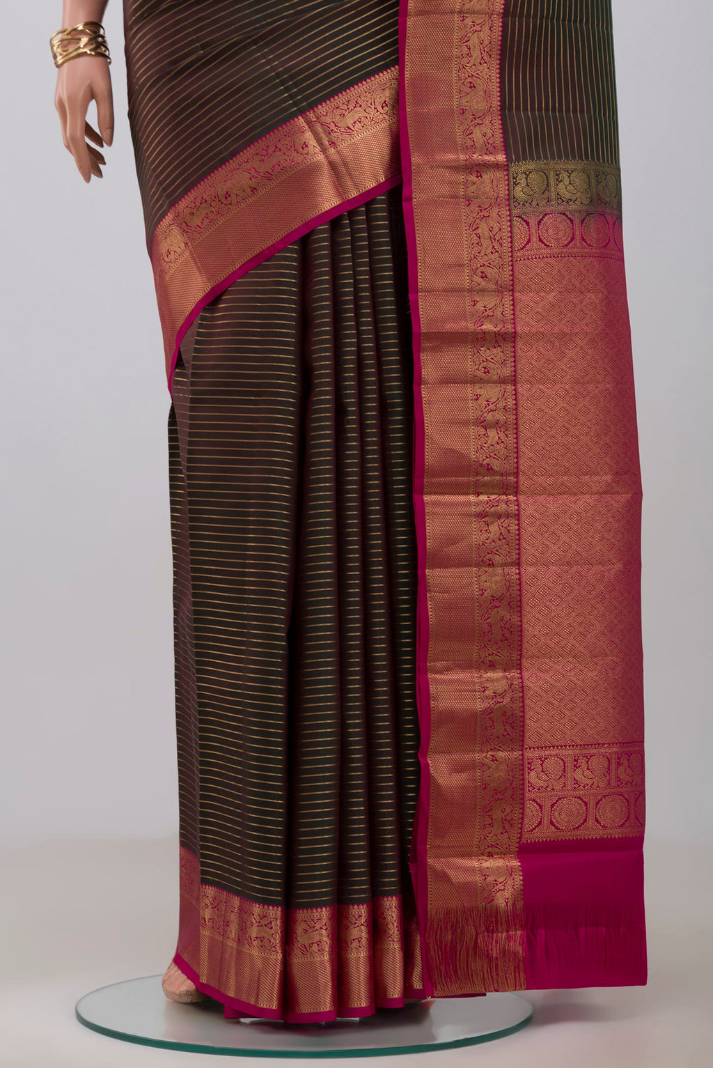 Pleats and pallu of Green Kanjivaram Saree with Stripes on the body and Zari Border. 