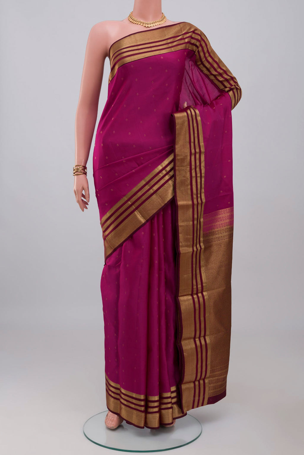 Pink Kanchipuram Silk Saree with Zari Butta on the body and Zari Border.  displayed on a mannequin