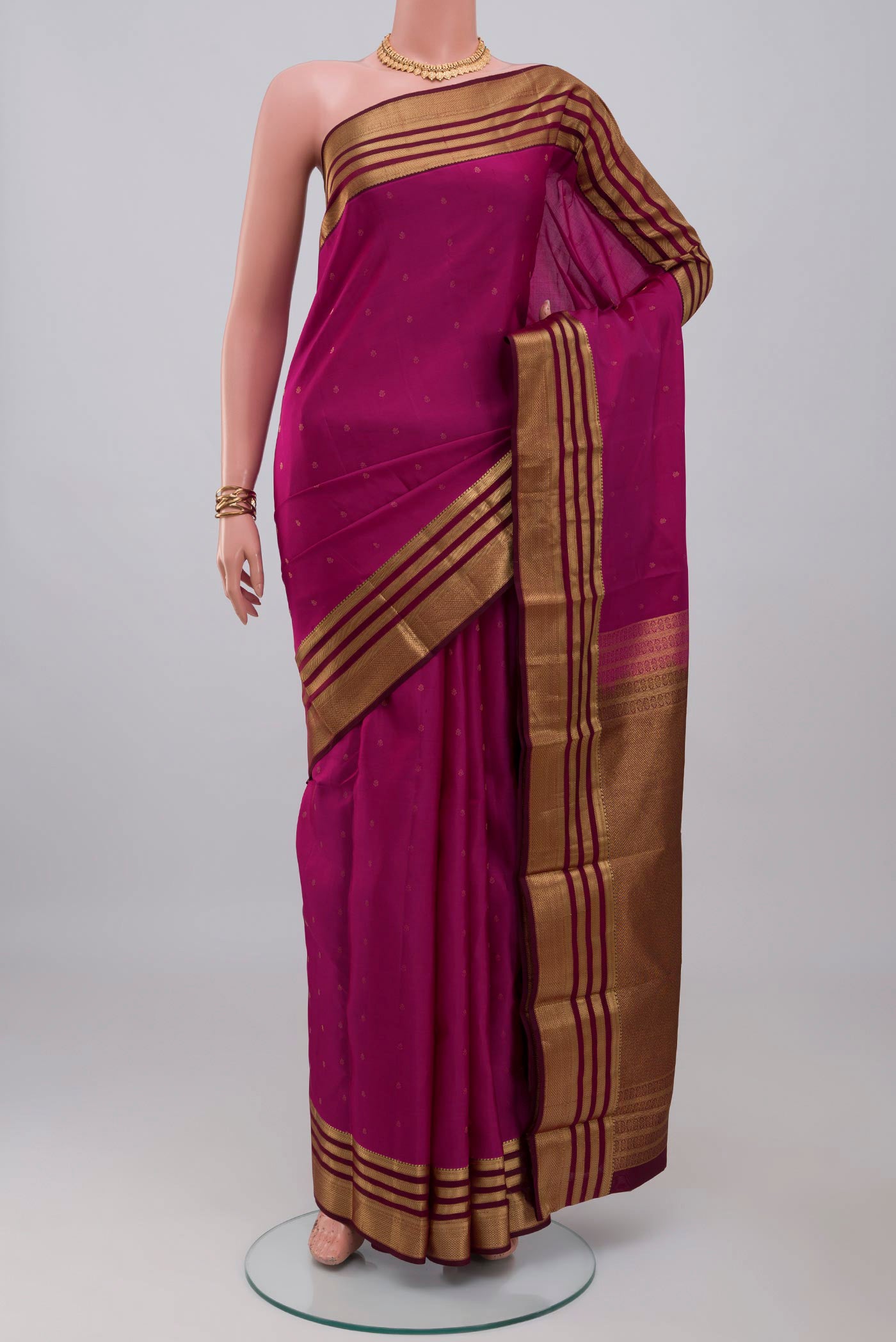 Pink Kanchipuram Silk Saree with Zari Butta on the body and Zari Border.  displayed on a mannequin