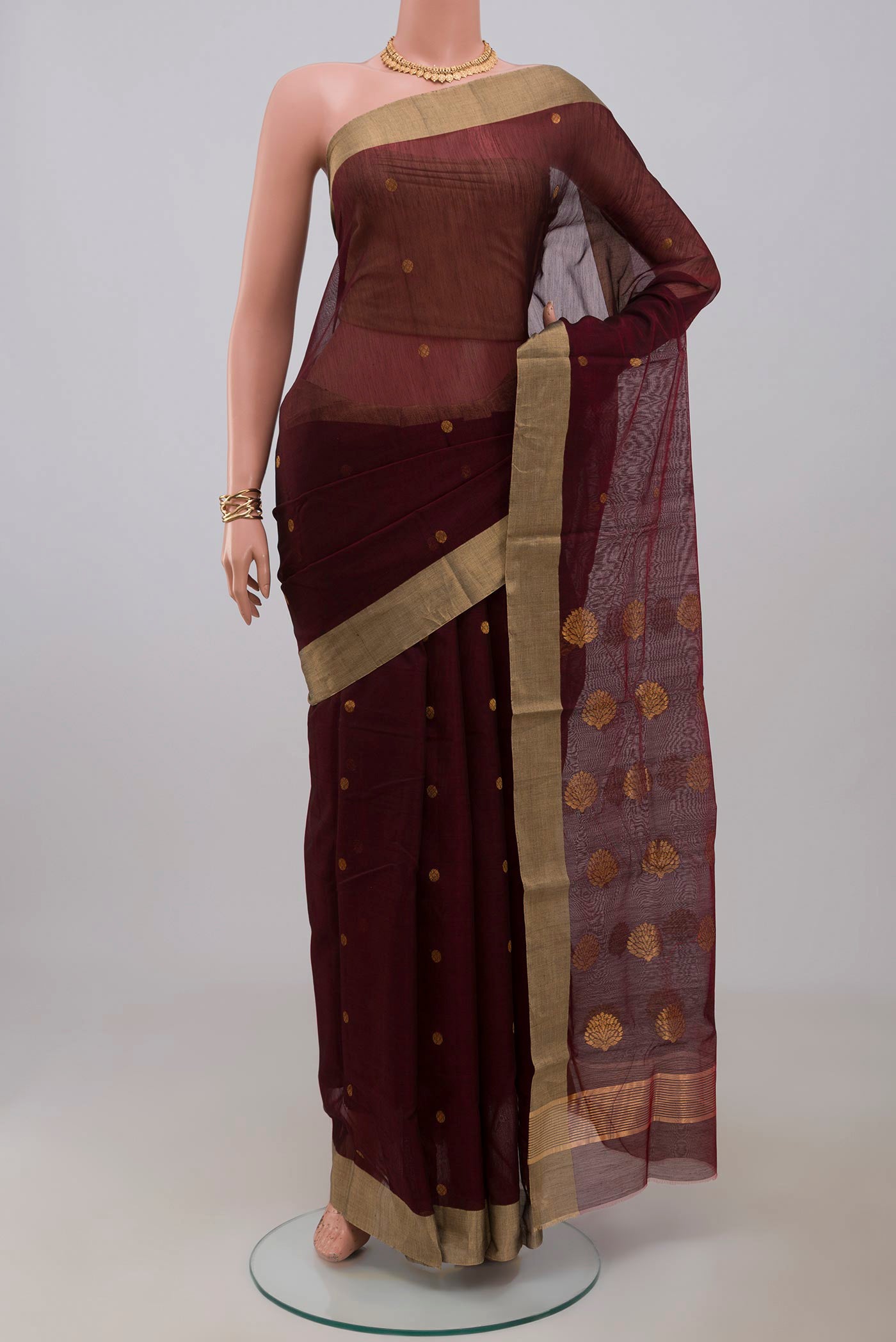 Maroon Chanderi Silk Cotton Saree with Zari Butta on the body and Zari Border.  displayed on a mannequin