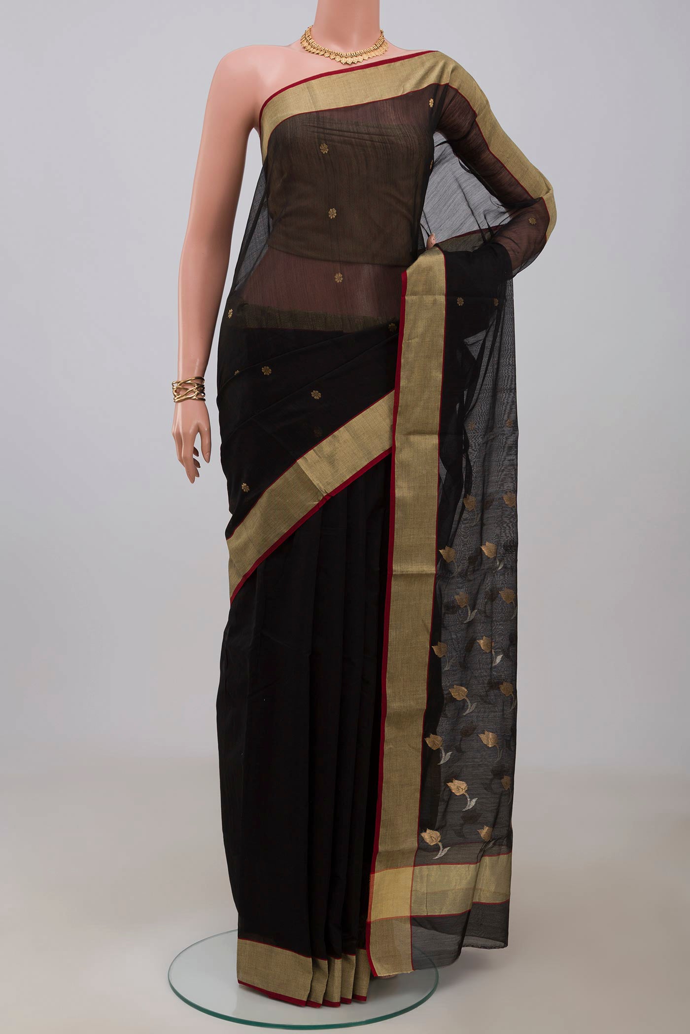 Black Chanderi Silk Cotton Saree with Zari Butta on the body and Zari Border.  displayed on a mannequin