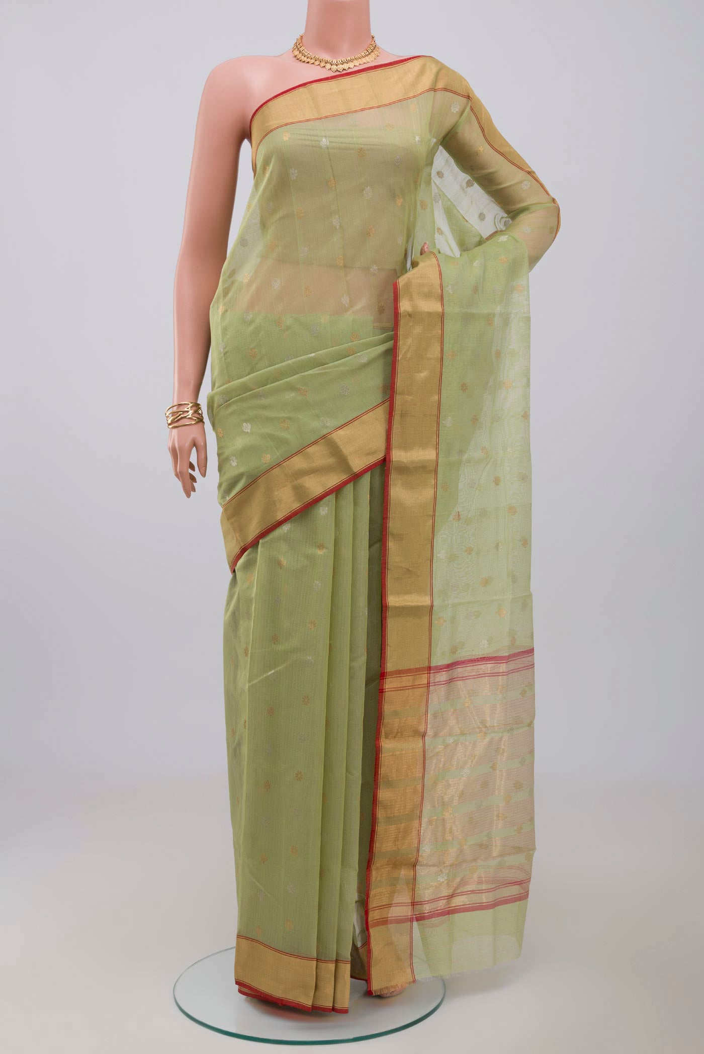 Green Chanderi Silk Cotton Saree with Zari Butta on the body and Zari Border.  displayed on a mannequin