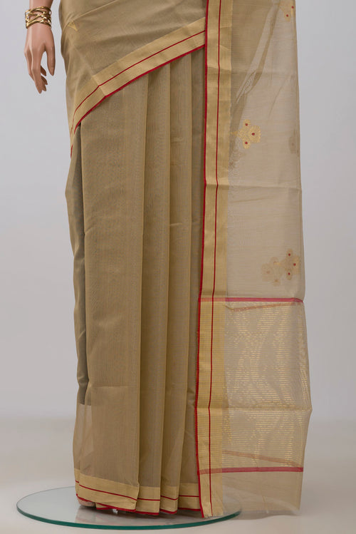 Pleats and pallu of Beige Chanderi Silk Cotton Saree with Zari And Thread Butta on the body and Zari Border. 