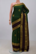 Green Kanchipuram Silk Saree with Zari Butta on the body and Zari Border.  displayed on a mannequin