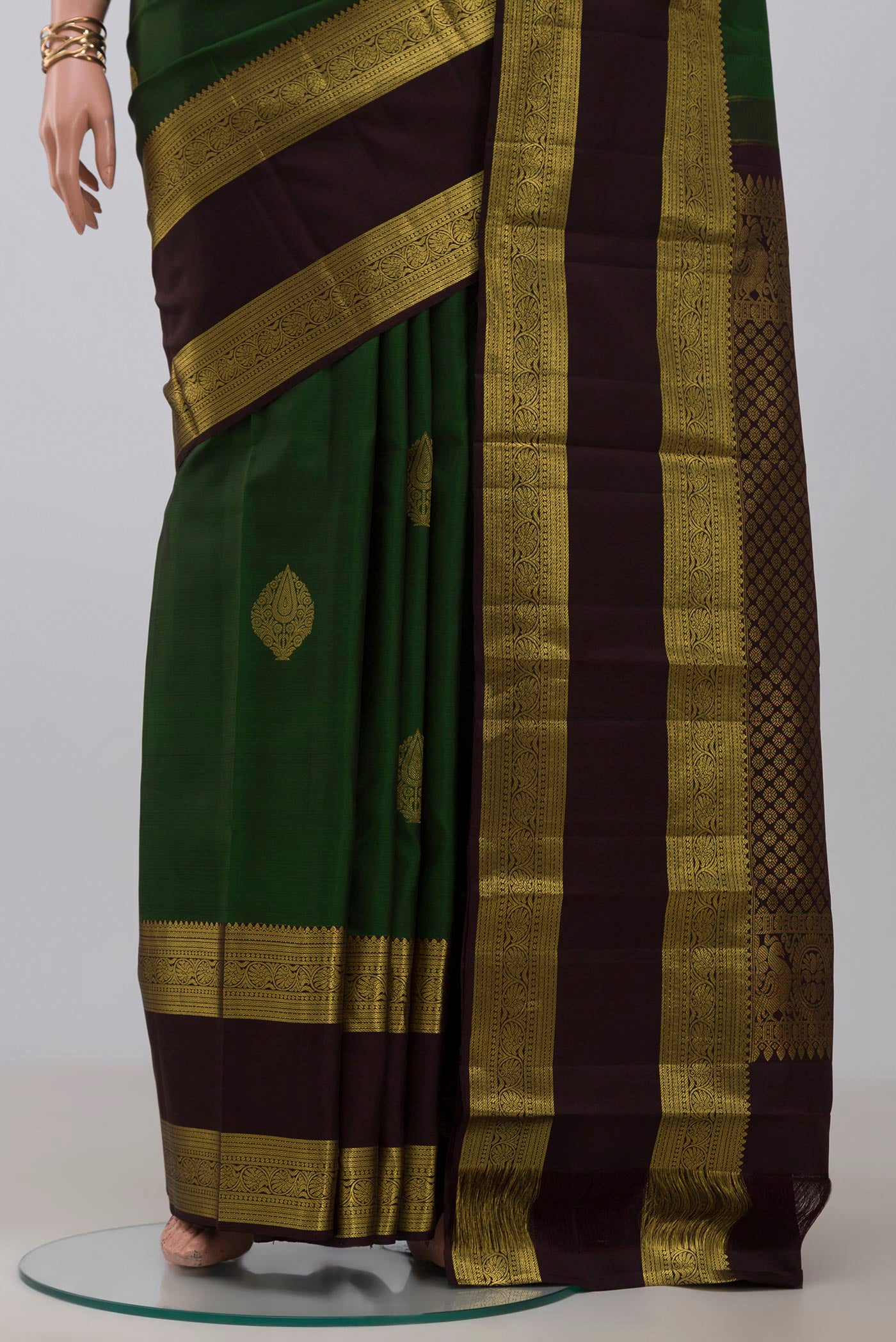 Pleats and pallu of Green Kanchipuram Silk Saree with Zari Butta on the body and Zari Border. 
