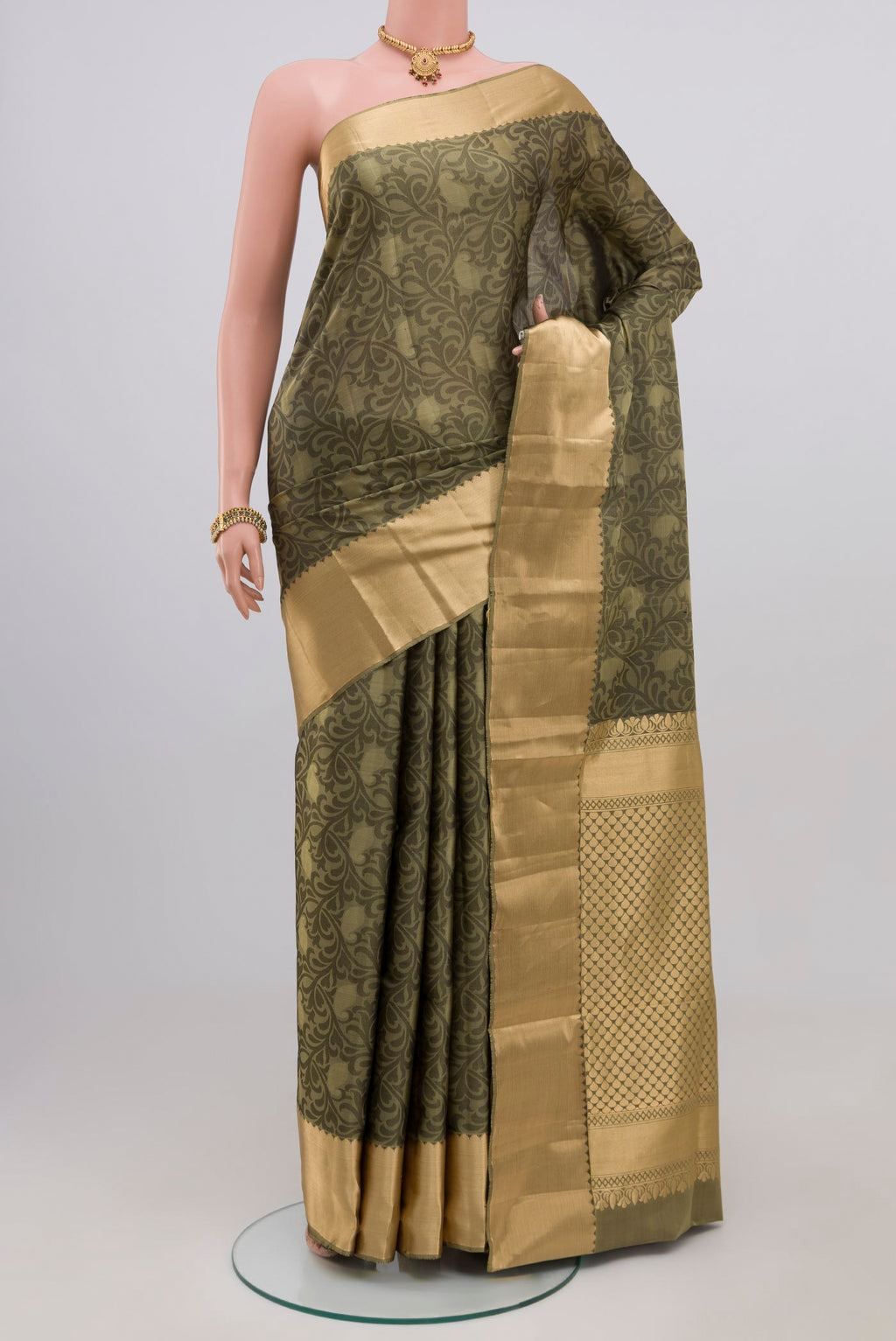 Green Soft Silk Saree with Jacquard design on the body and Zari Border.  displayed on a mannequin