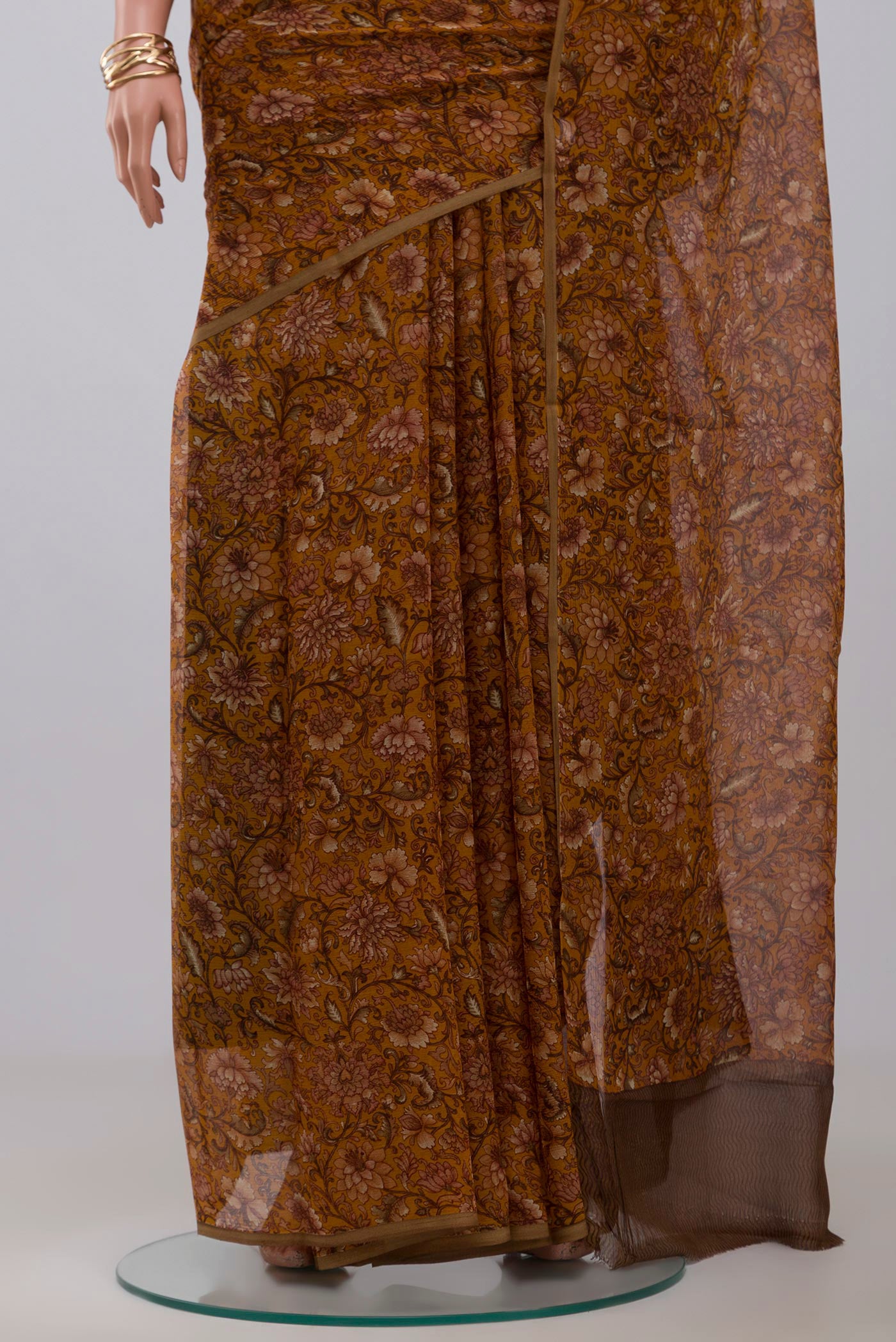 Pleats and pallu of Mustard Chiffon Saree with Printed design on the body and Without Border. 