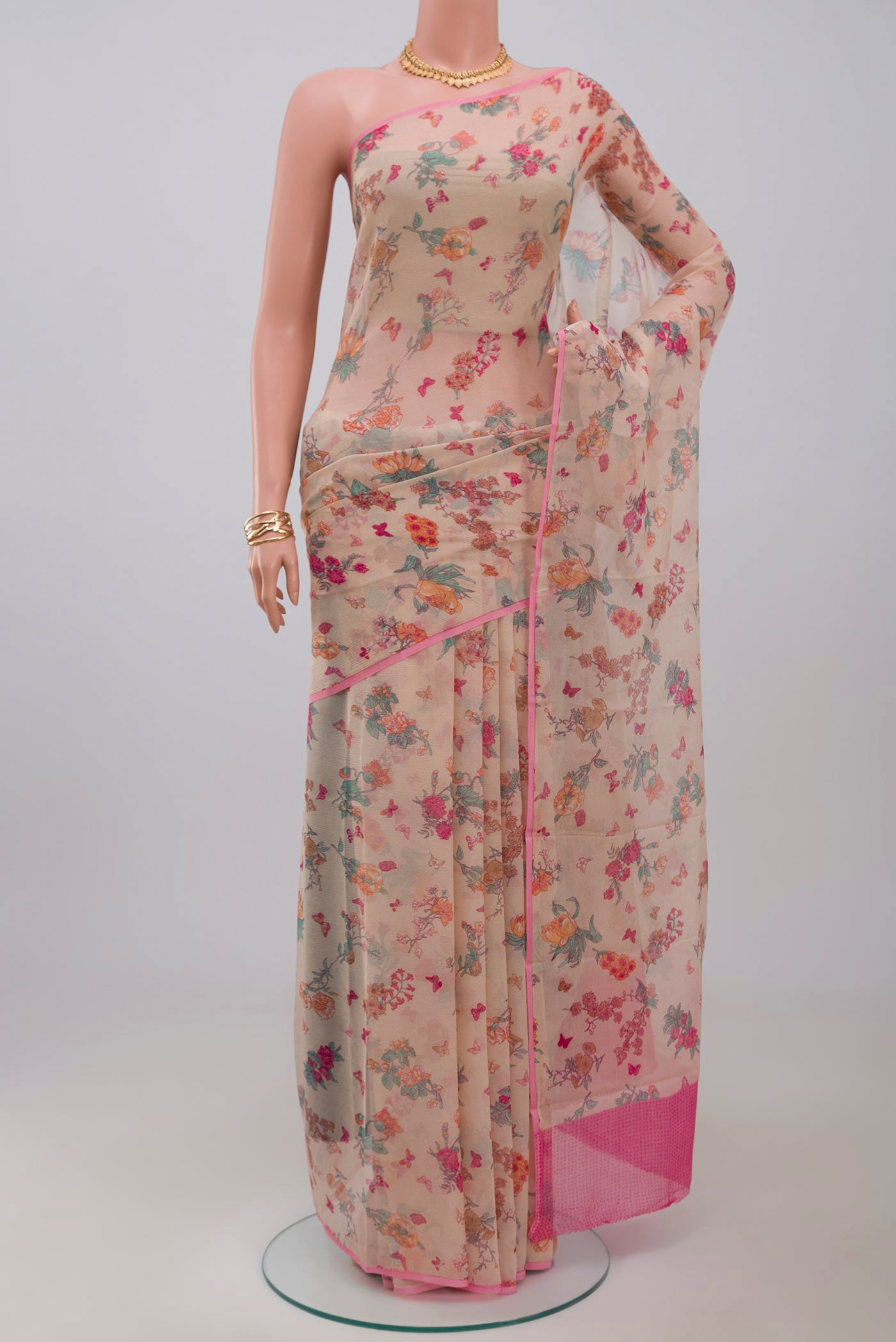 Cream Chiffon Saree with Printed design on the body and Without Border.  displayed on a mannequin