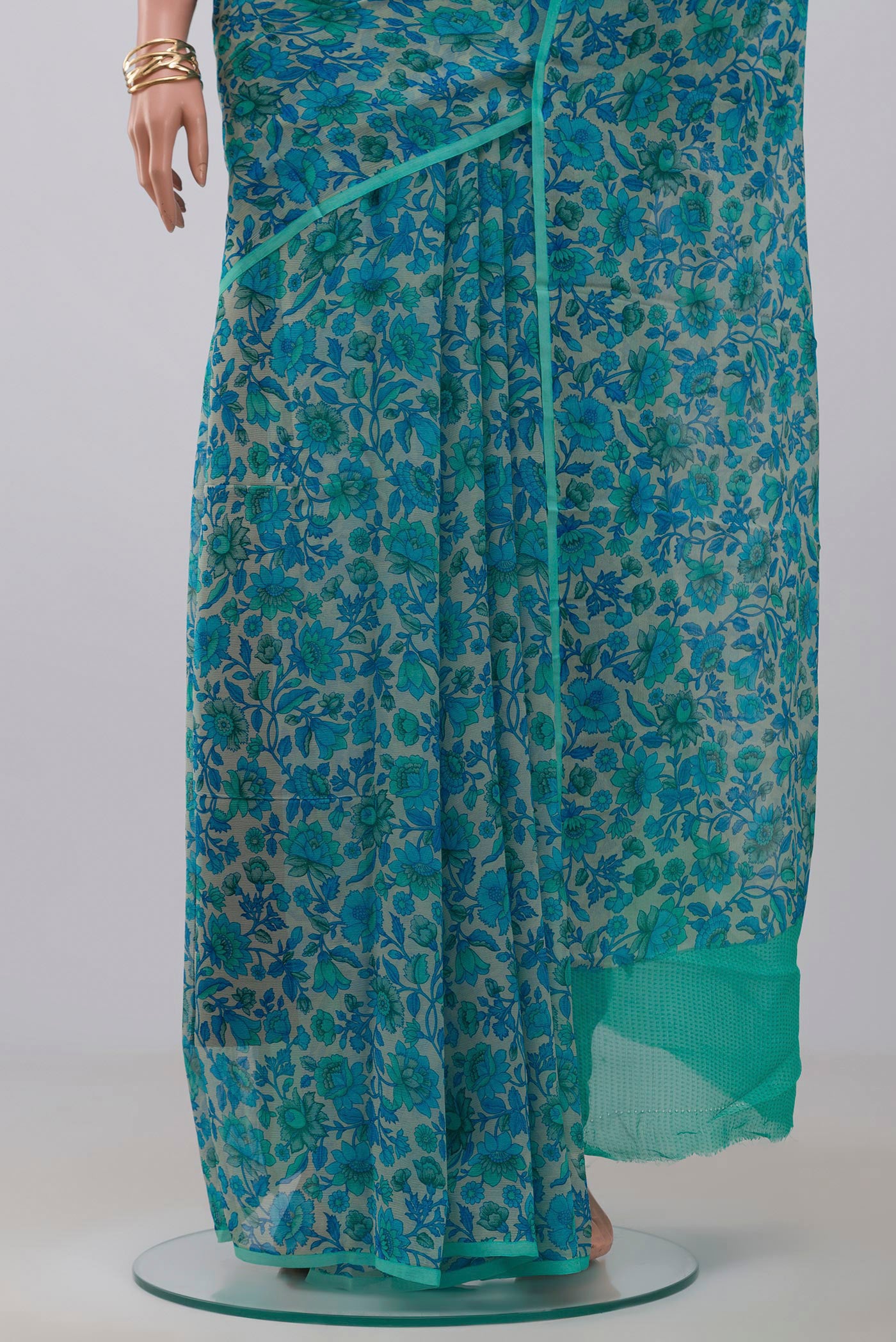 Pleats and pallu of Cream Chiffon Saree with Printed design on the body and Without Border. 