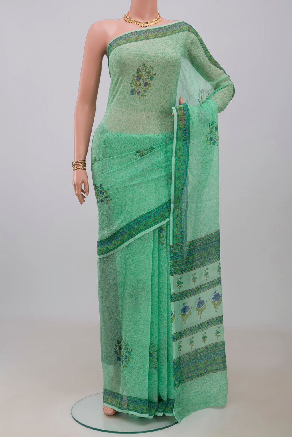 Sea Green Mysore Chiffon Saree with Printed design on the body and Printed Border.  displayed on a mannequin