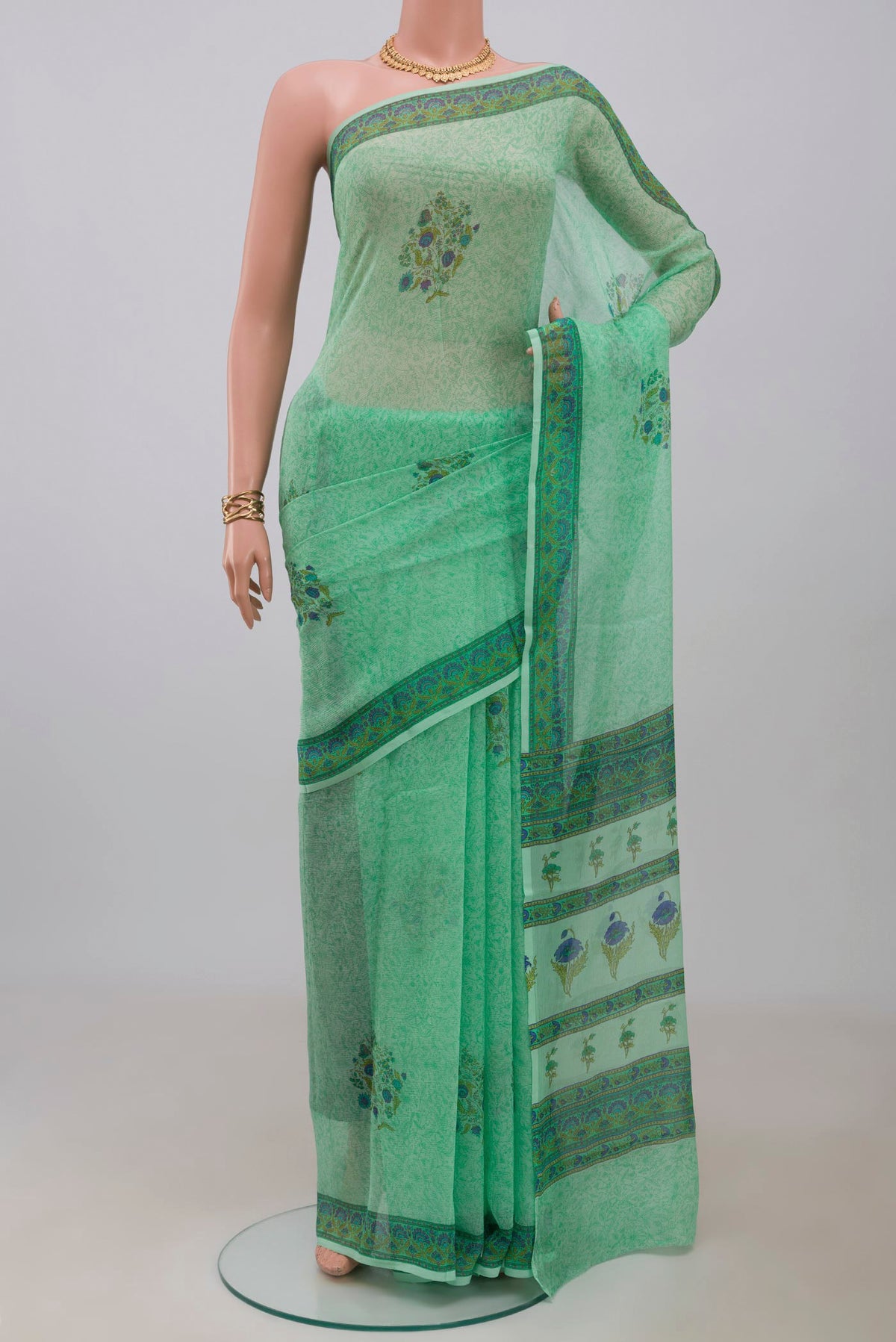 Sea Green Mysore Chiffon Saree with Printed design on the body and Printed Border.  displayed on a mannequin