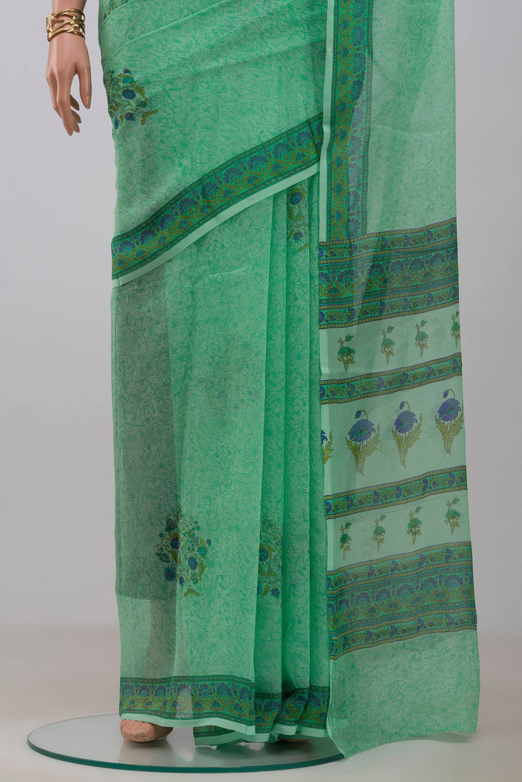 Pleats and pallu of Sea Green Mysore Chiffon Saree with Printed design on the body and Printed Border. 
