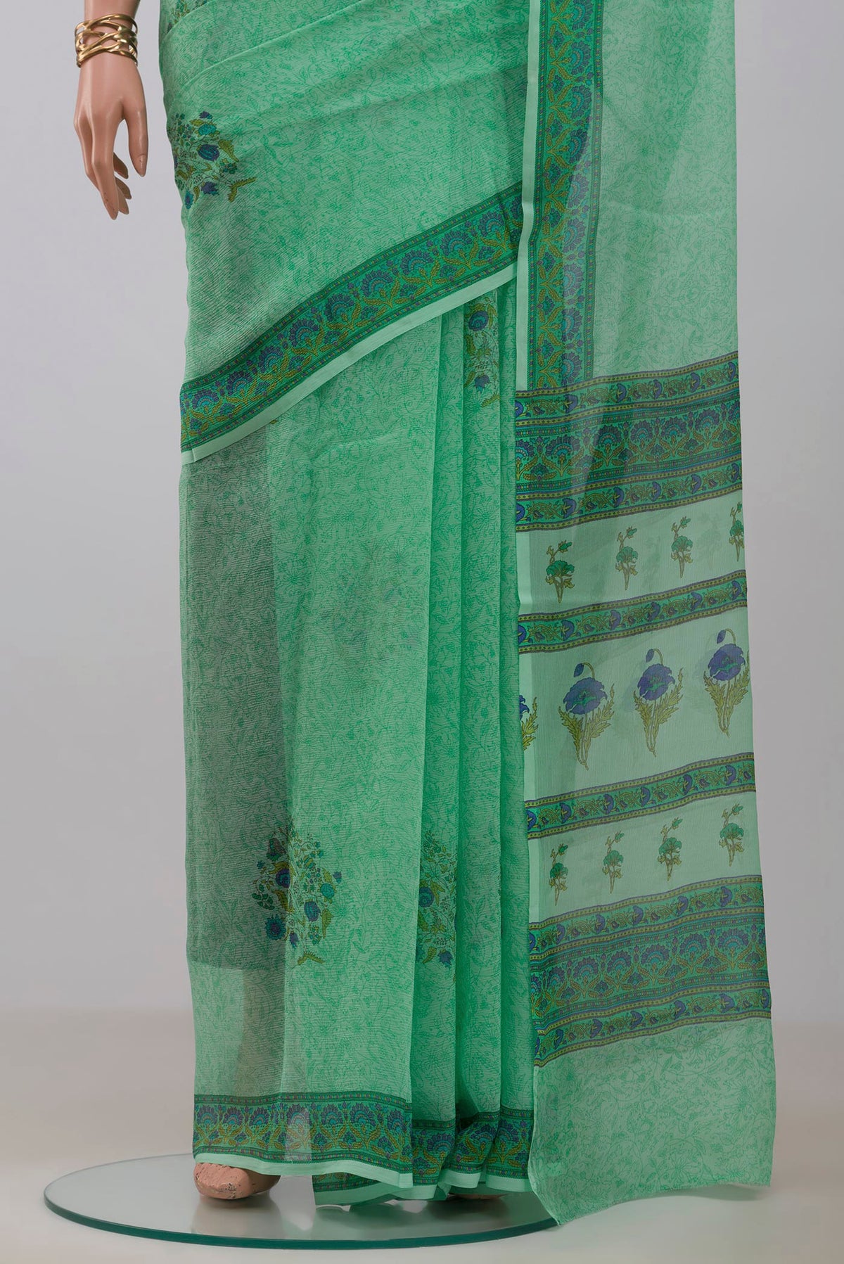 Pleats and pallu of Sea Green Mysore Chiffon Saree with Printed design on the body and Printed Border. 