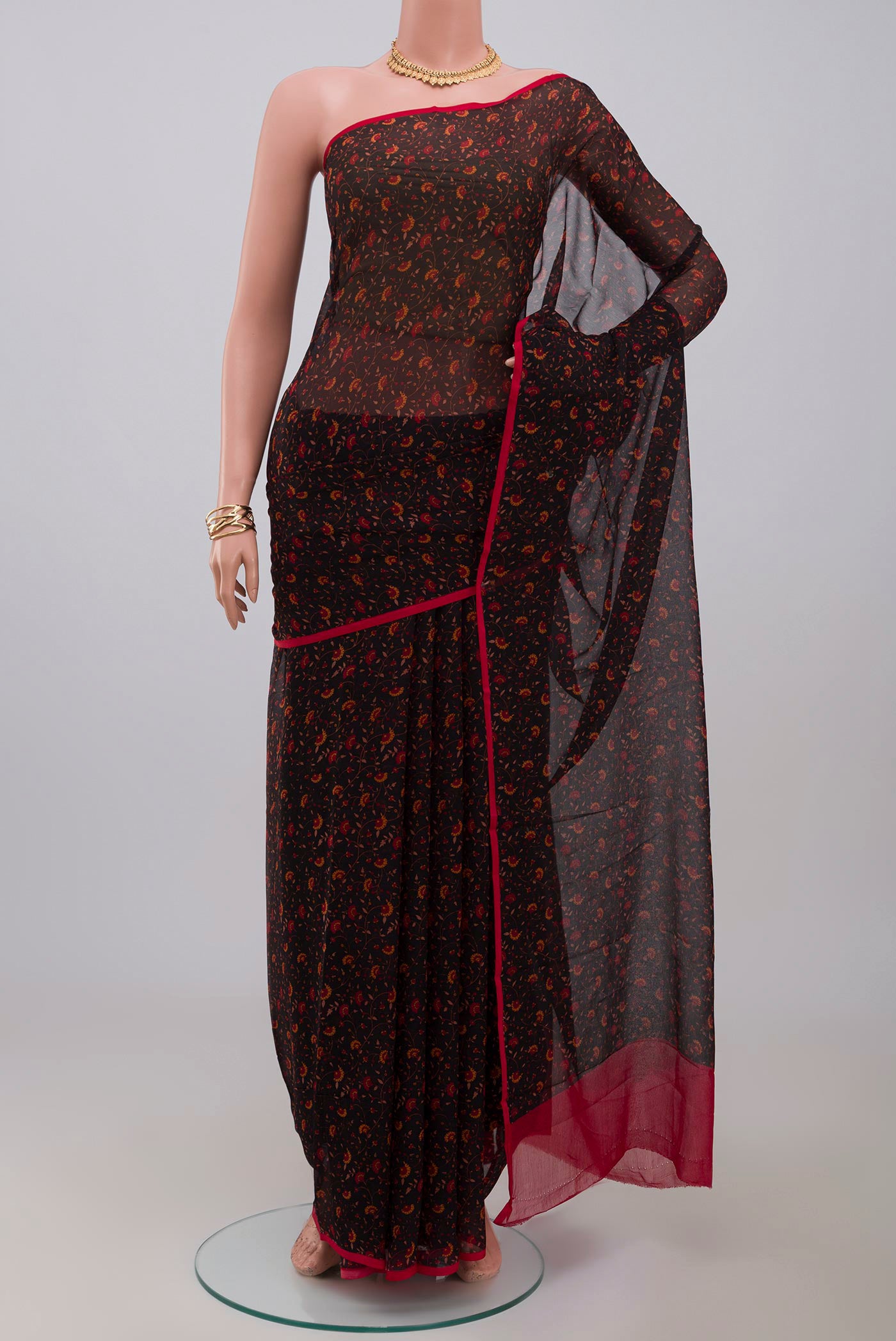 Black Chiffon Saree with Printed design on the body and Without Border.  displayed on a mannequin