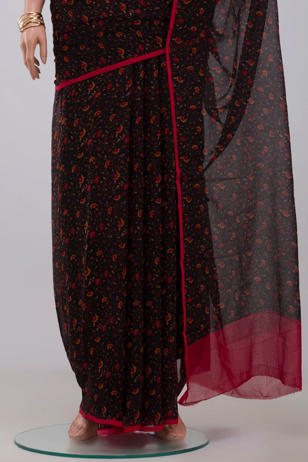 Pleats and pallu of Black Chiffon Saree with Printed design on the body and Without Border. 