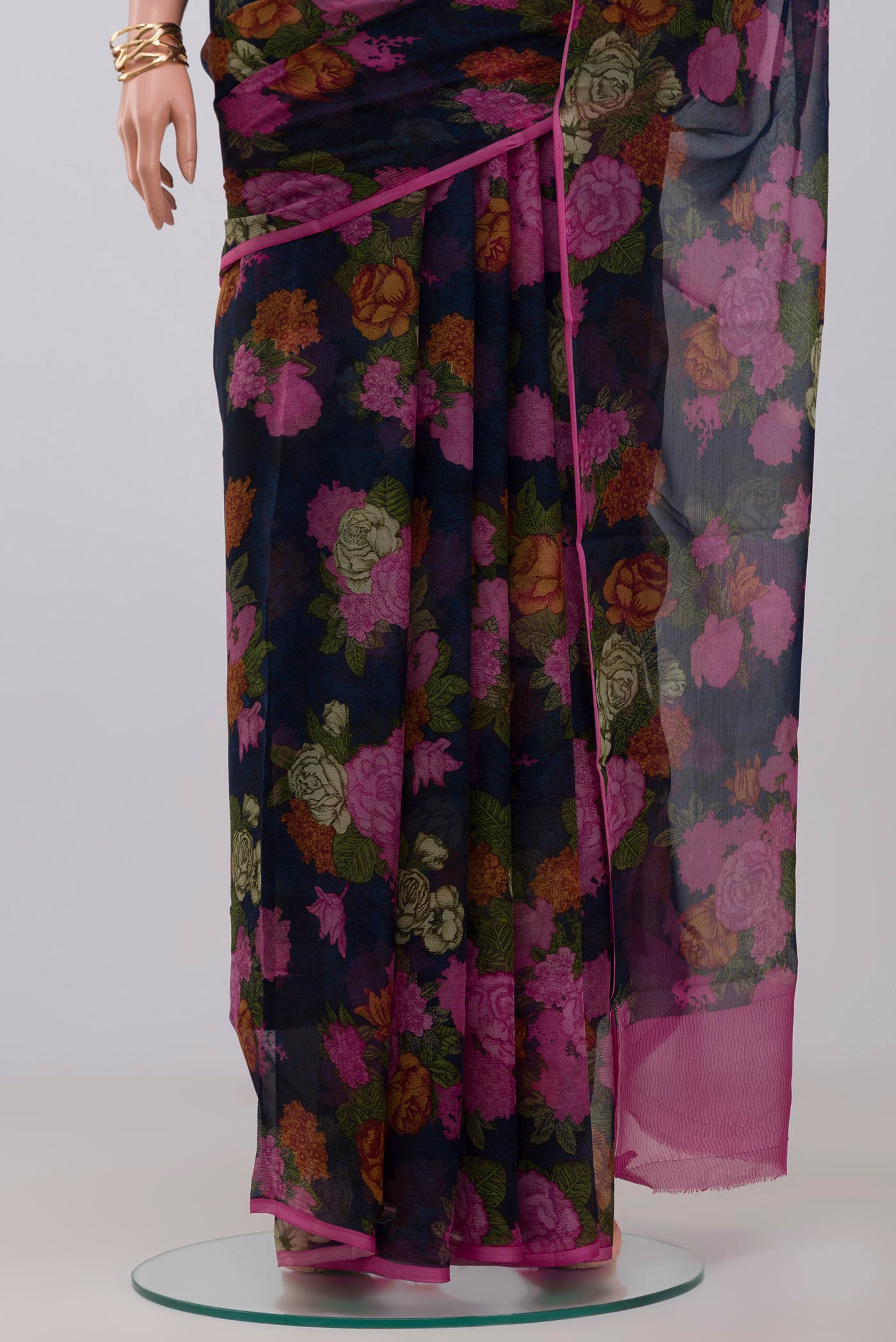 Pleats and pallu of Blue Chiffon Saree with Printed design on the body and Without Border. 