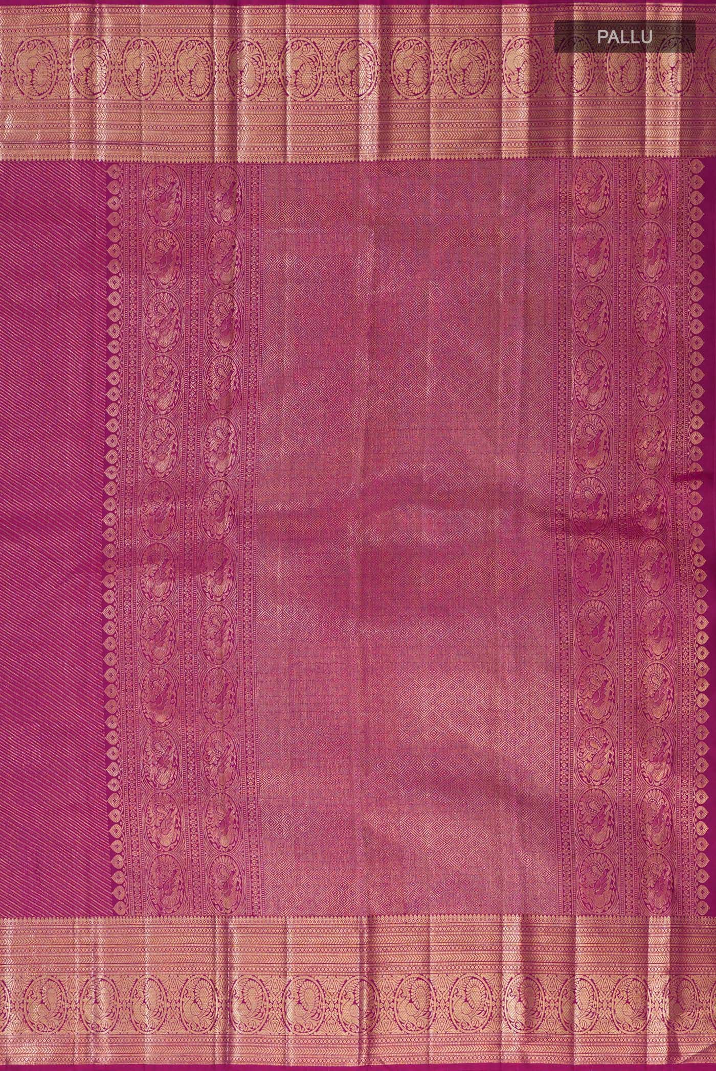 Close up image of the pallu of Magenta Kanchipuram Silk Saree with Zari Brocade on the body and Zari Border. 