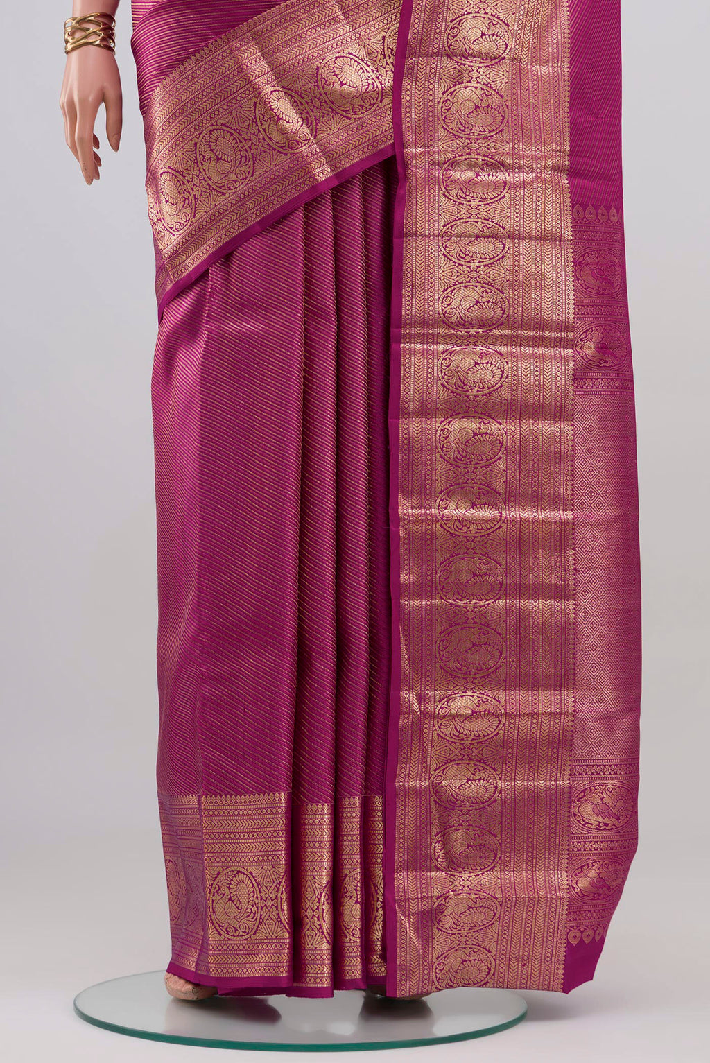 Pleats and pallu of Magenta Kanchipuram Silk Saree with Zari Brocade on the body and Zari Border. 