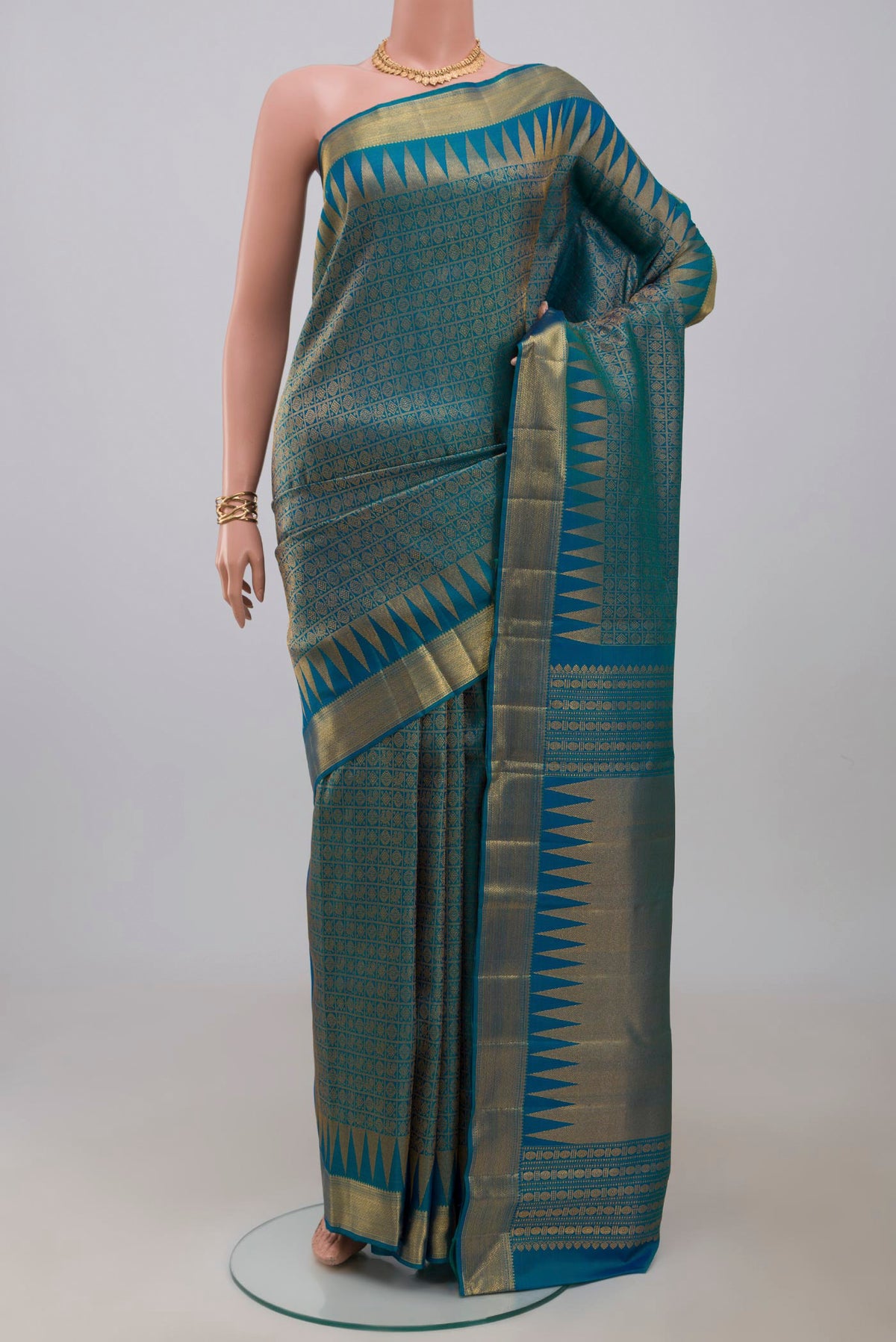 Peacock Blue Kanchipuram Silk Saree with Zari Brocade on the body and Zari Border.  displayed on a mannequin