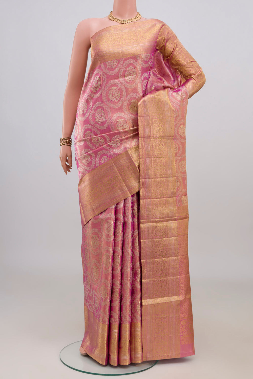 Pink Kanjivaram Tissue Saree with Zari Brocade on the body and Zari Border.  displayed on a mannequin