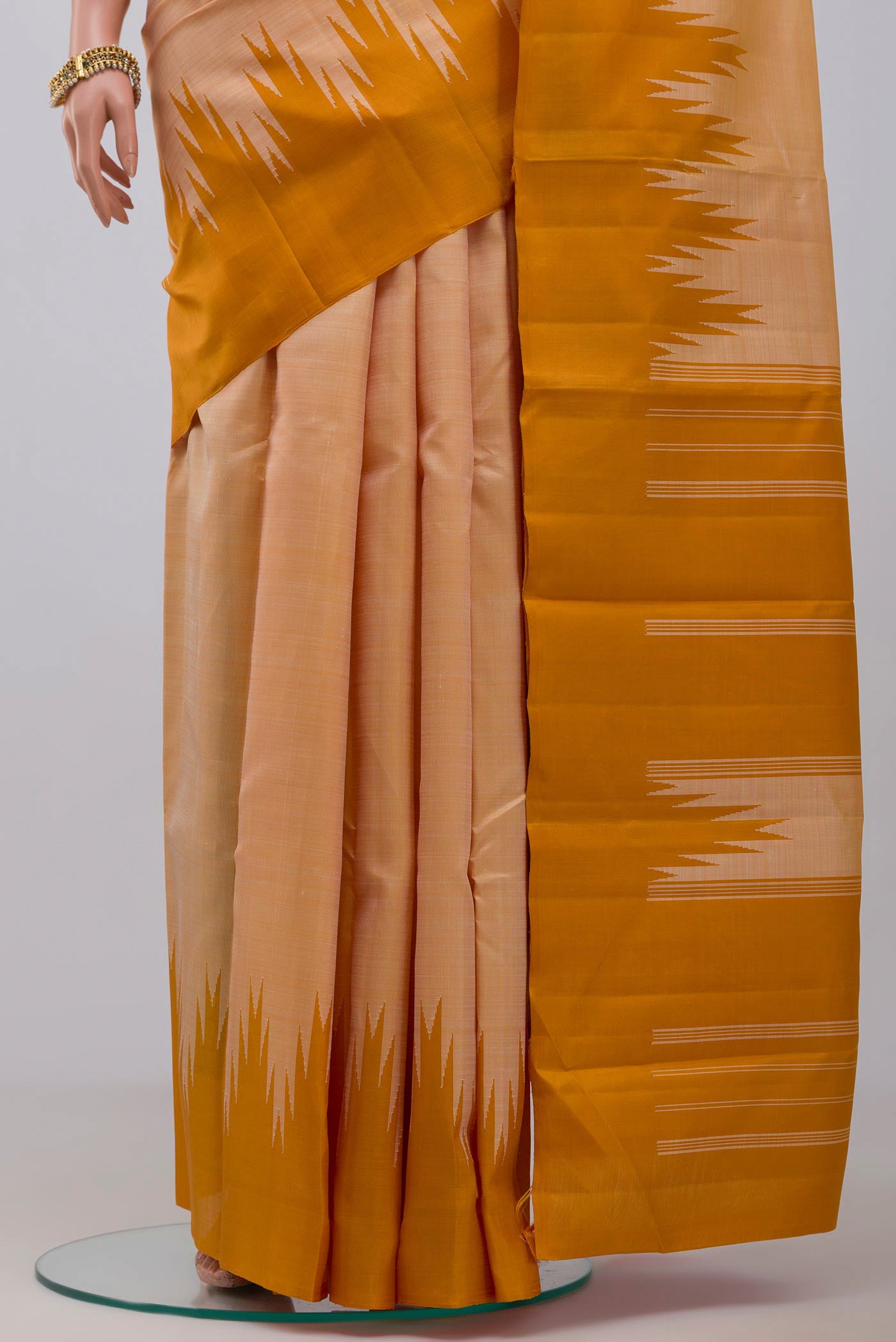 Pleats and pallu of Mustard Kanchipuram Silk Saree with Plain Body and Temple Border. 