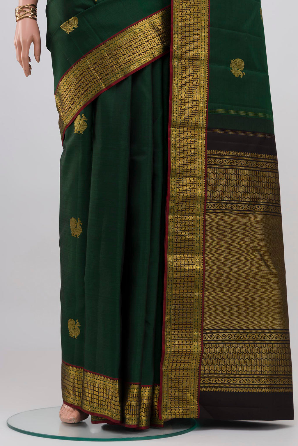 Pleats and pallu of Bottle Green Kanjivaram Silk Saree with Zari Butta on the body and Zari Border. 