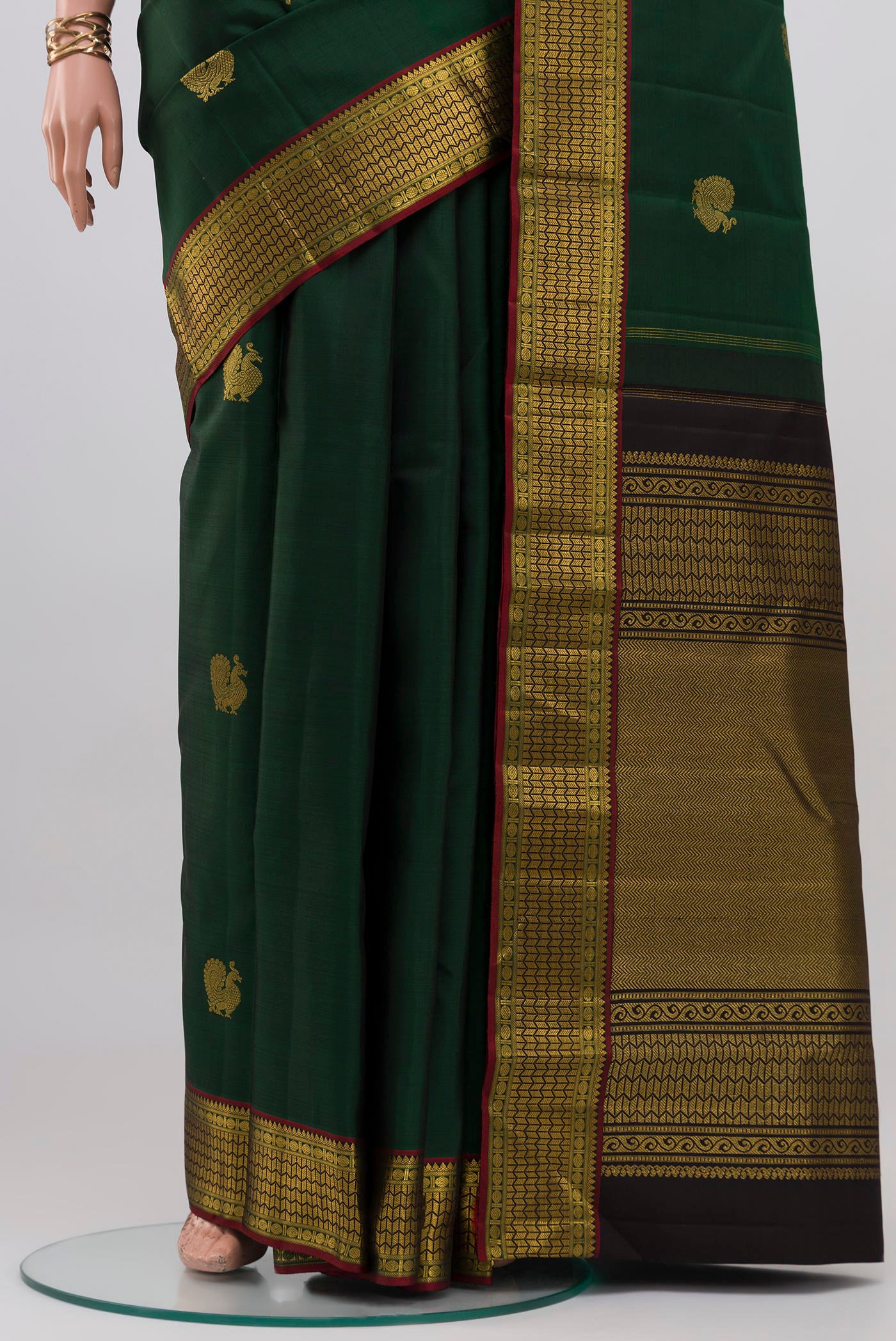 Pleats and pallu of Bottle Green Kanjivaram Silk Saree with Zari Butta on the body and Zari Border. 