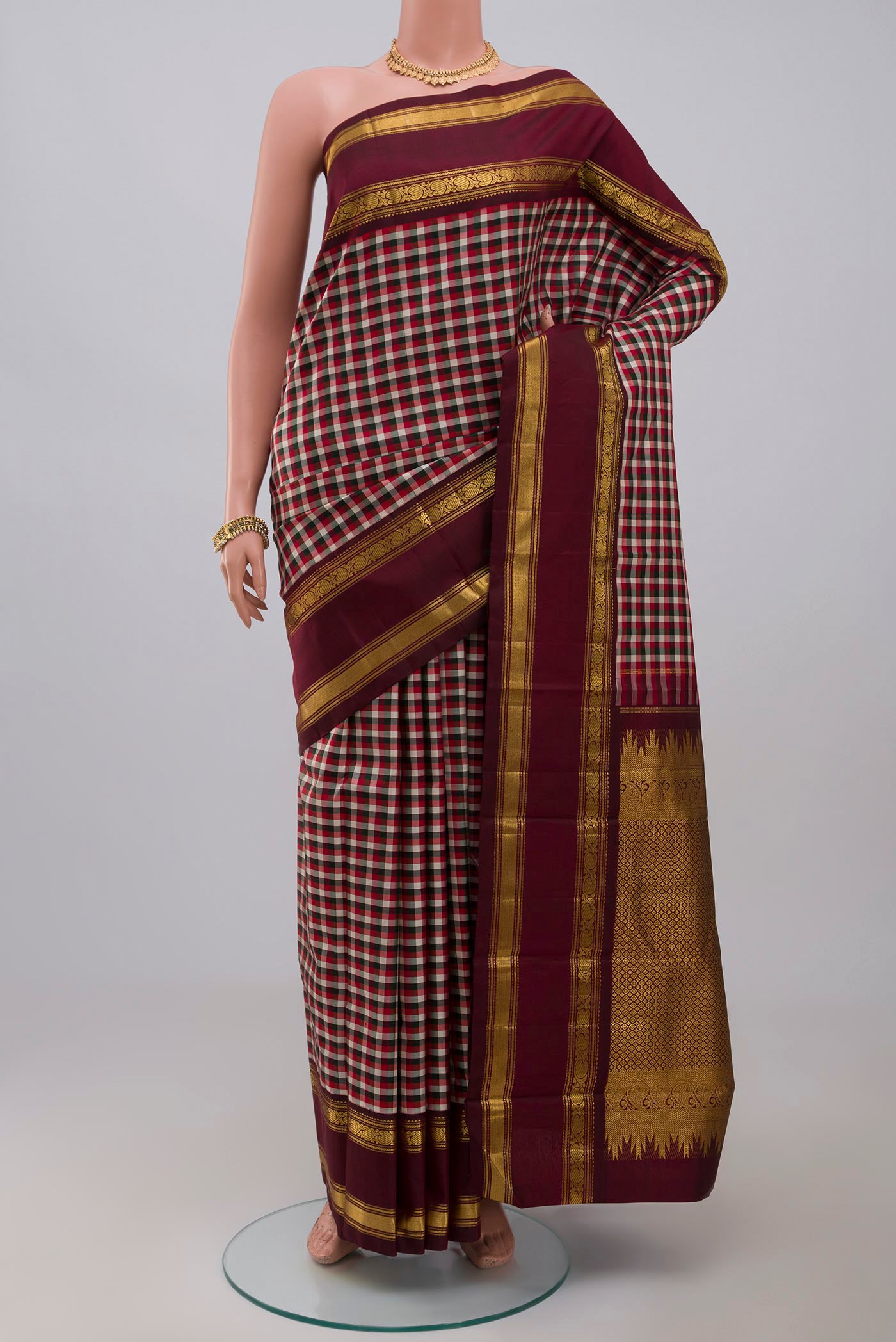 Pure Silk Pure Zari Multi Color Kanchipuram Saree with Checked design on the body and Zari Border.  displayed on a mannequin