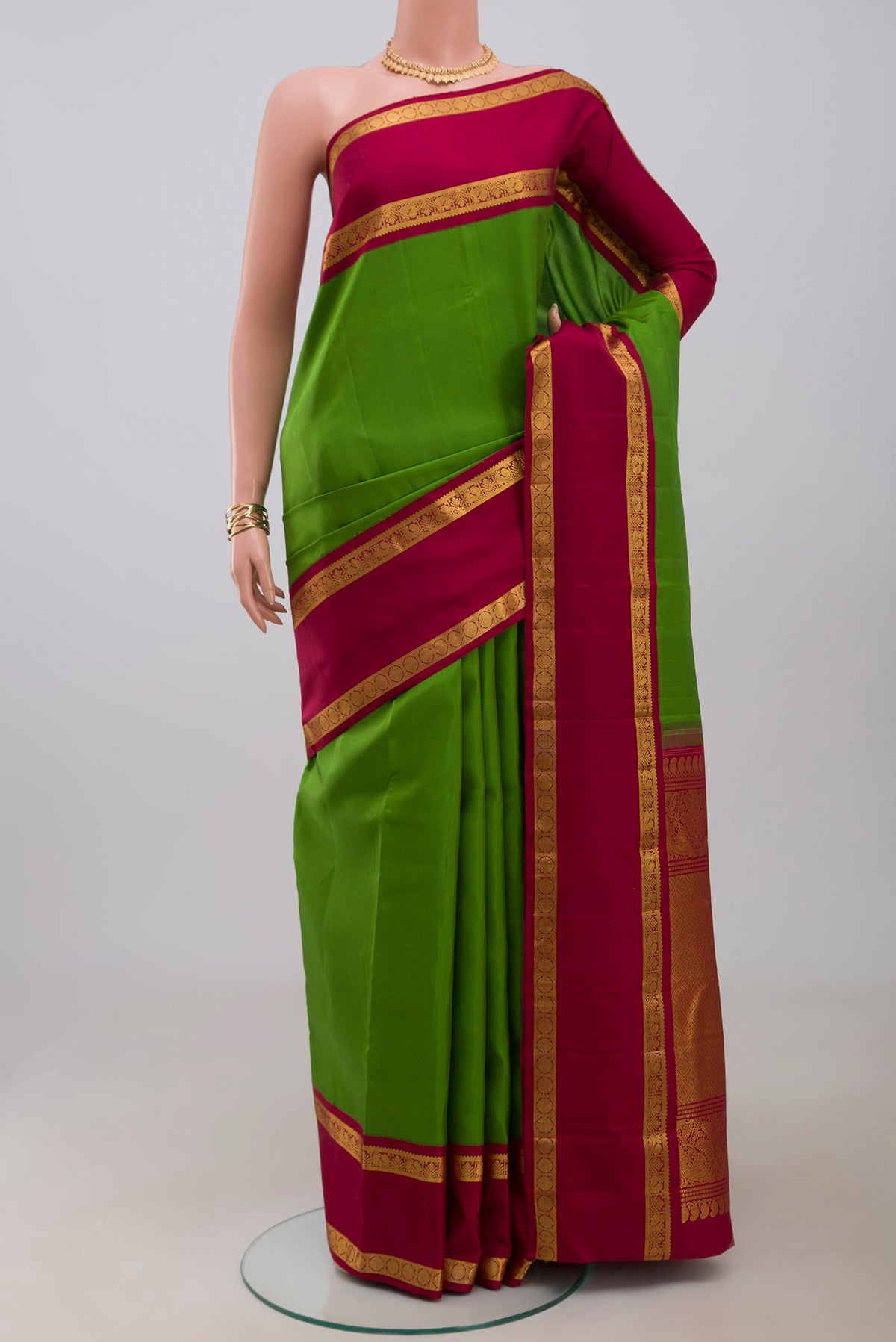 Pure Silk Pure Zari Green Kanchipuram Saree with Plain Body and Zari Border.  displayed on a mannequin