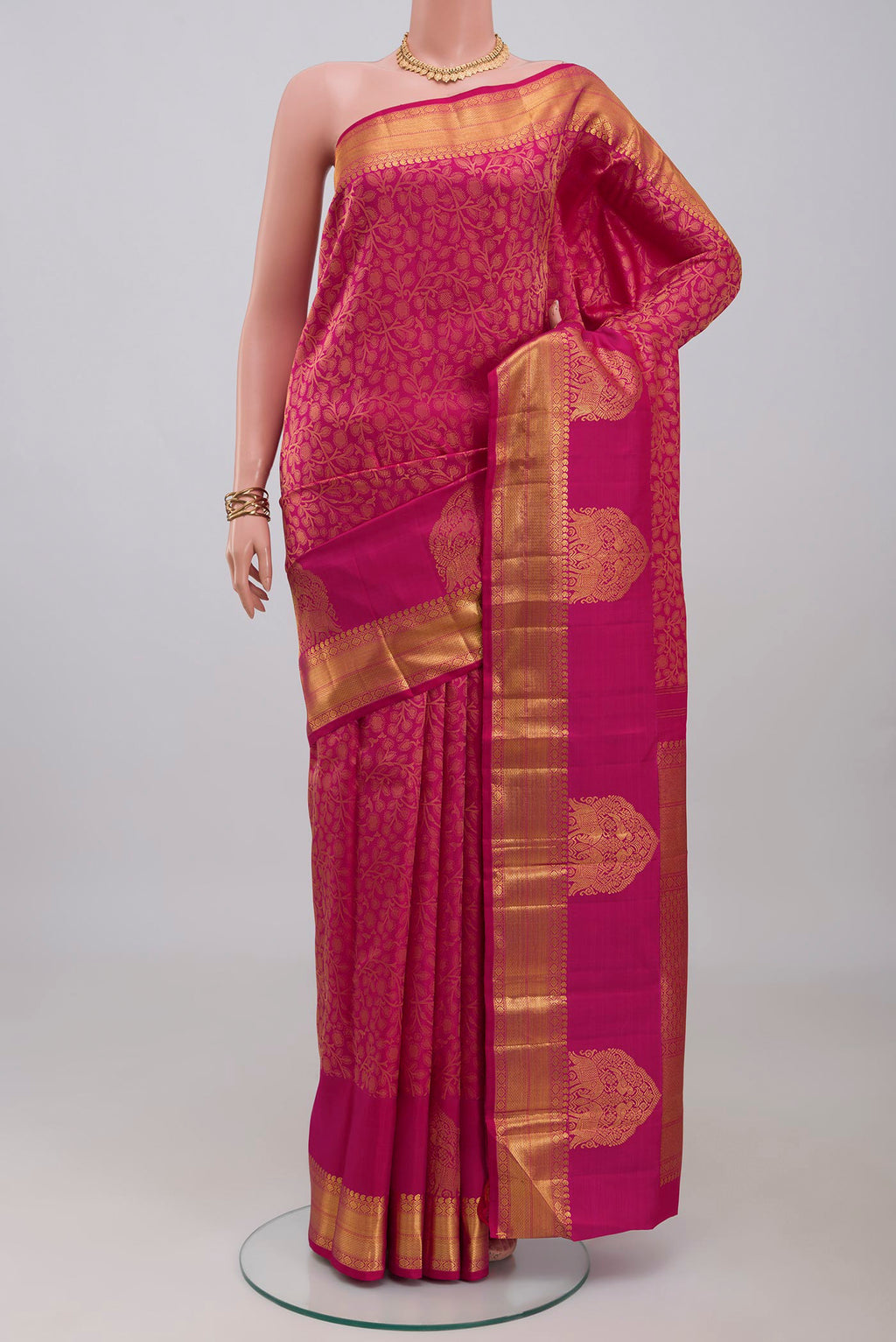 Pink Kanchipuram Silk Saree with Jacquard design on the body and Zari Border.  displayed on a mannequin