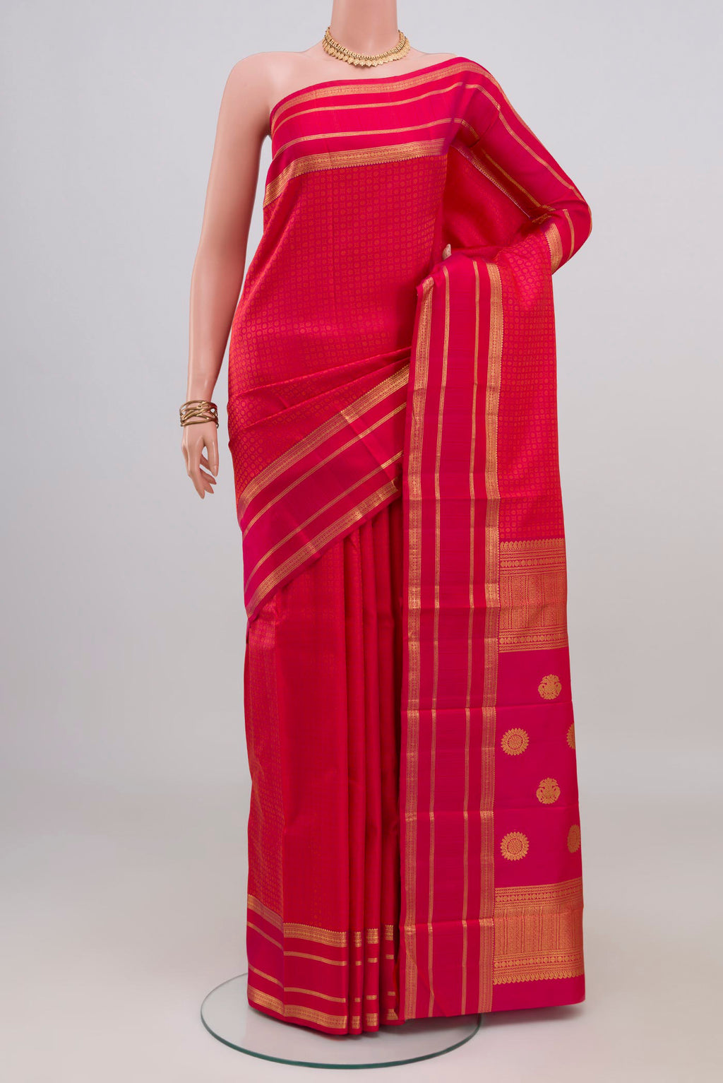 Pink Kanjivaram Silk Saree with Jacquard design on the body and Zari Border.  displayed on a mannequin
