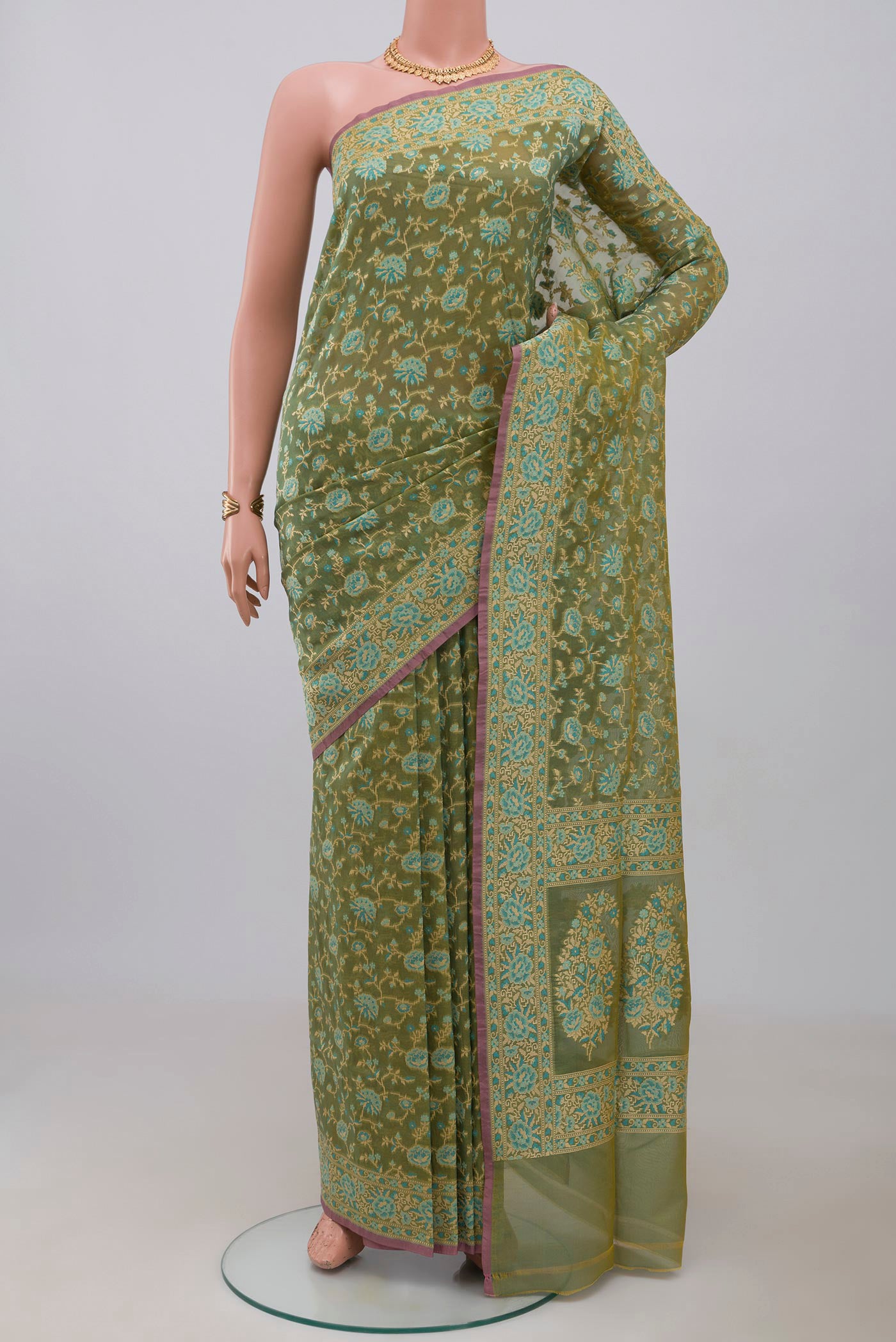 Olive Green Banarasi Silk Saree with Zari And Thread Butta on the body and Zari Border.  displayed on a mannequin