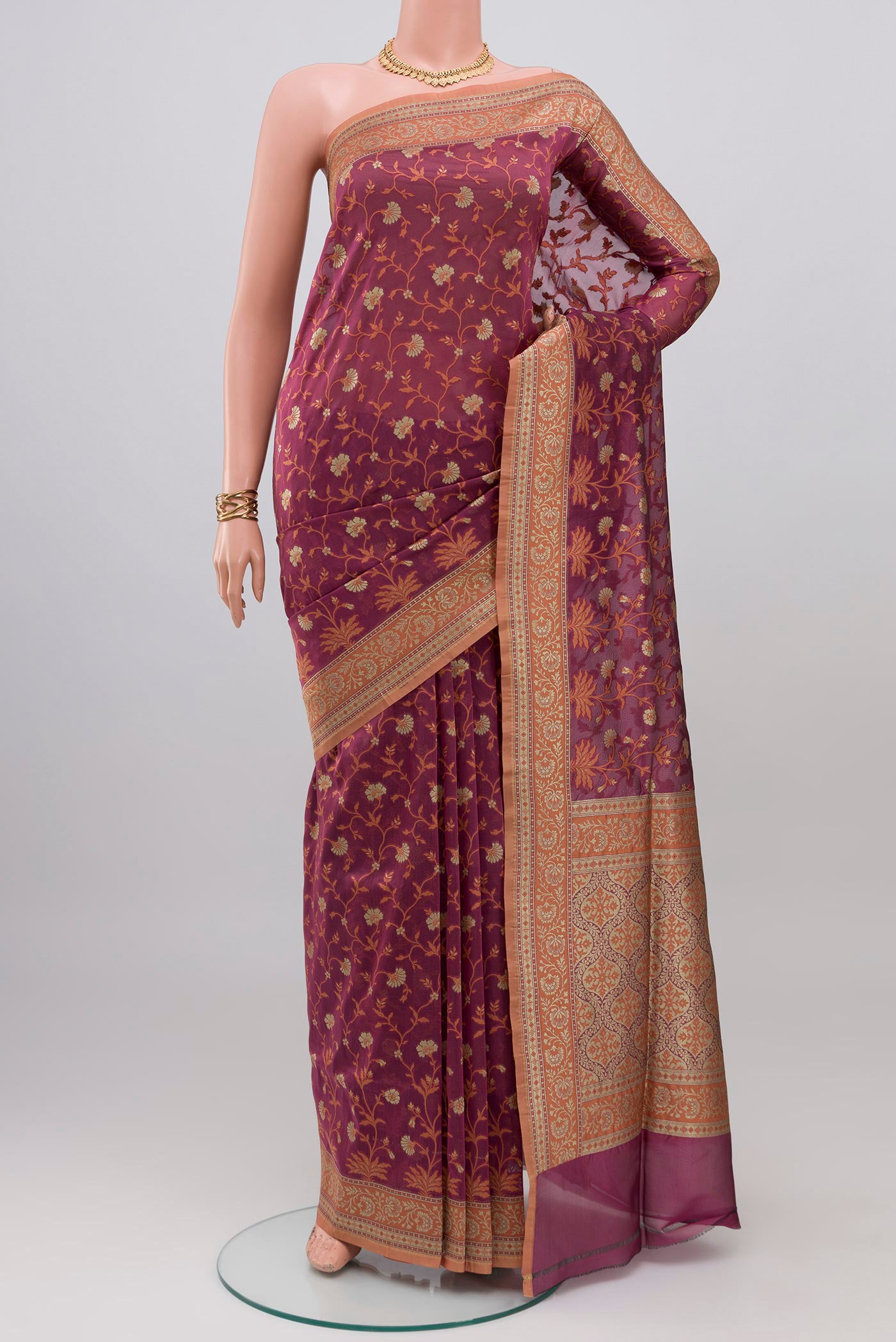 Mauve Banarasi Silk Saree with Zari And Thread Butta on the body and Zari Border.  displayed on a mannequin