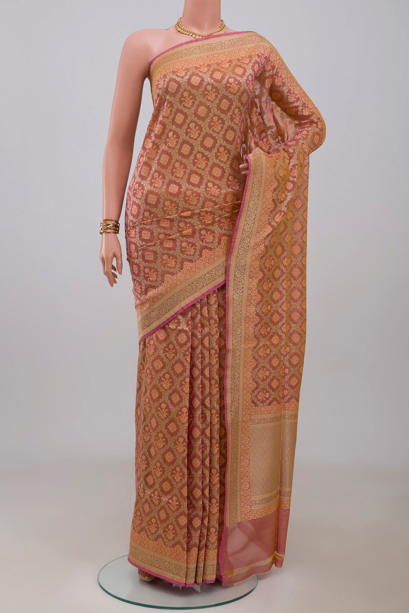 Peach Banarasi Silk Saree with Zari And Thread Butta on the body and Zari Border.  displayed on a mannequin