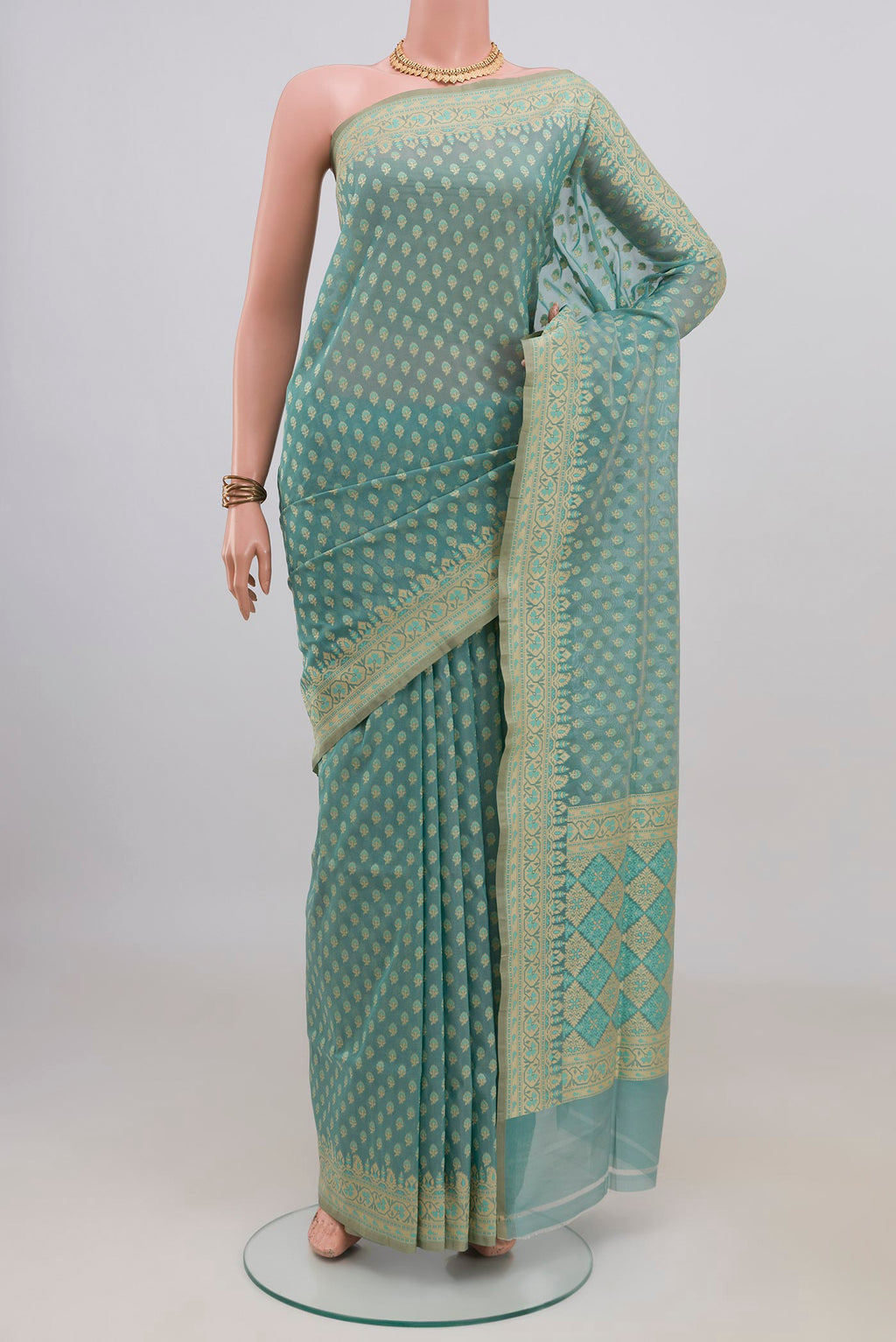 Pure Silk Sky Blue Banarasi Saree with Zari Butta on the body and Zari Border.  displayed on a mannequin