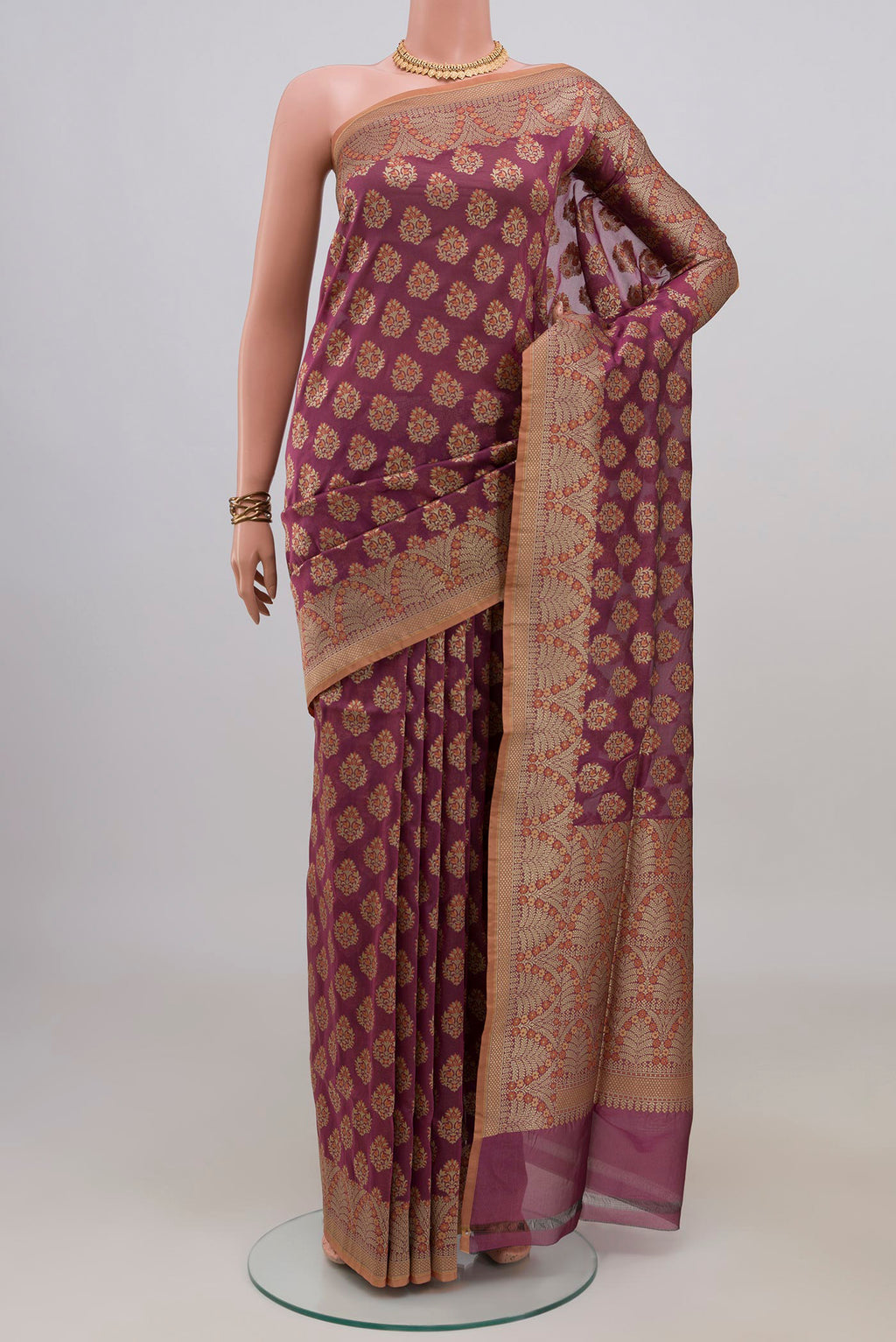 Pure Silk Mauve Banarasi Saree with Zari And Thread Butta on the body and Zari Border.  displayed on a mannequin