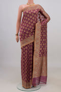 Pure Silk Mauve Banarasi Saree with Zari And Thread Butta on the body and Zari Border.  displayed on a mannequin