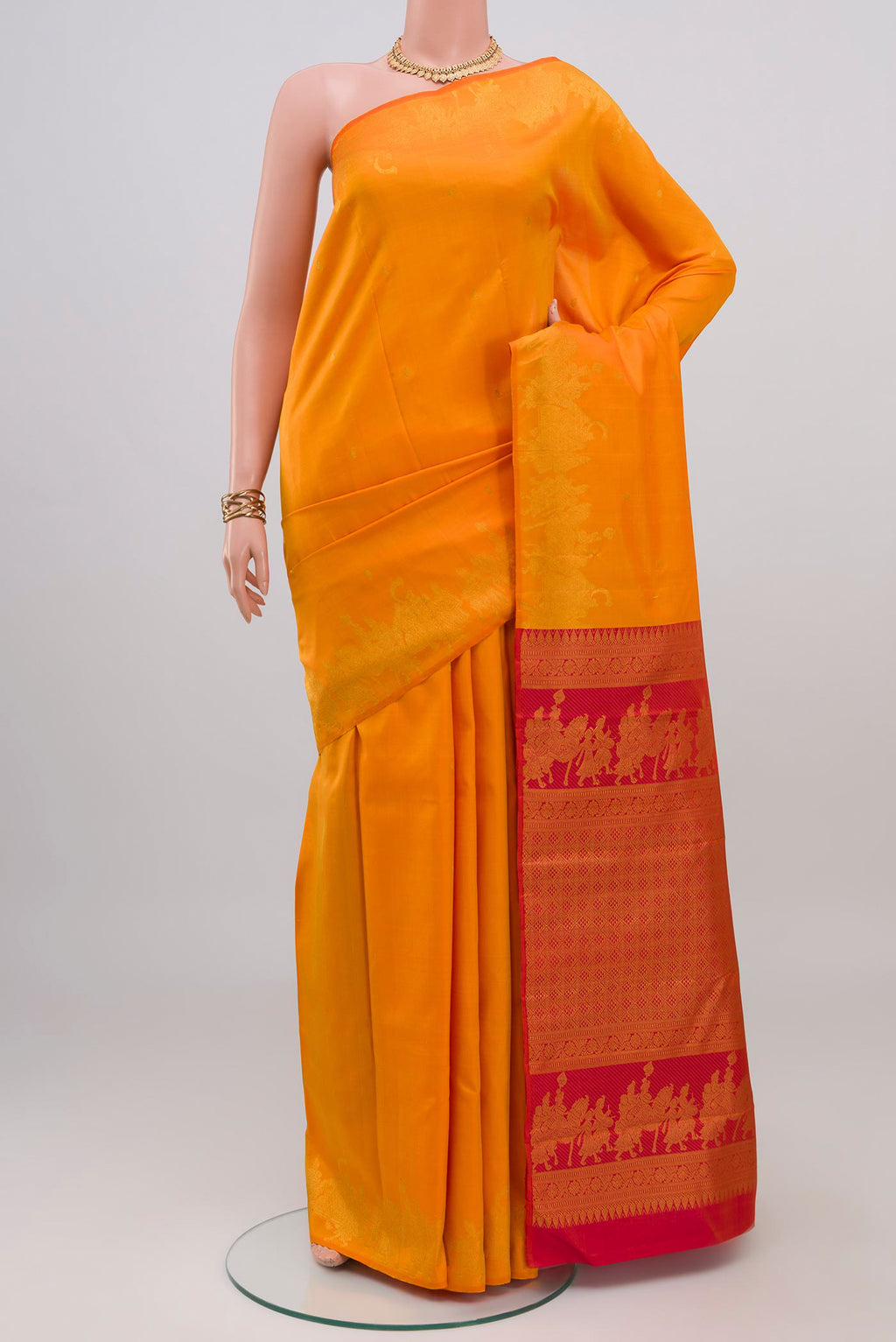 Pure Silk Pure Zari Yellow Kanjivaram Saree with Zari Butta on the body and Fancy Border.  displayed on a mannequin